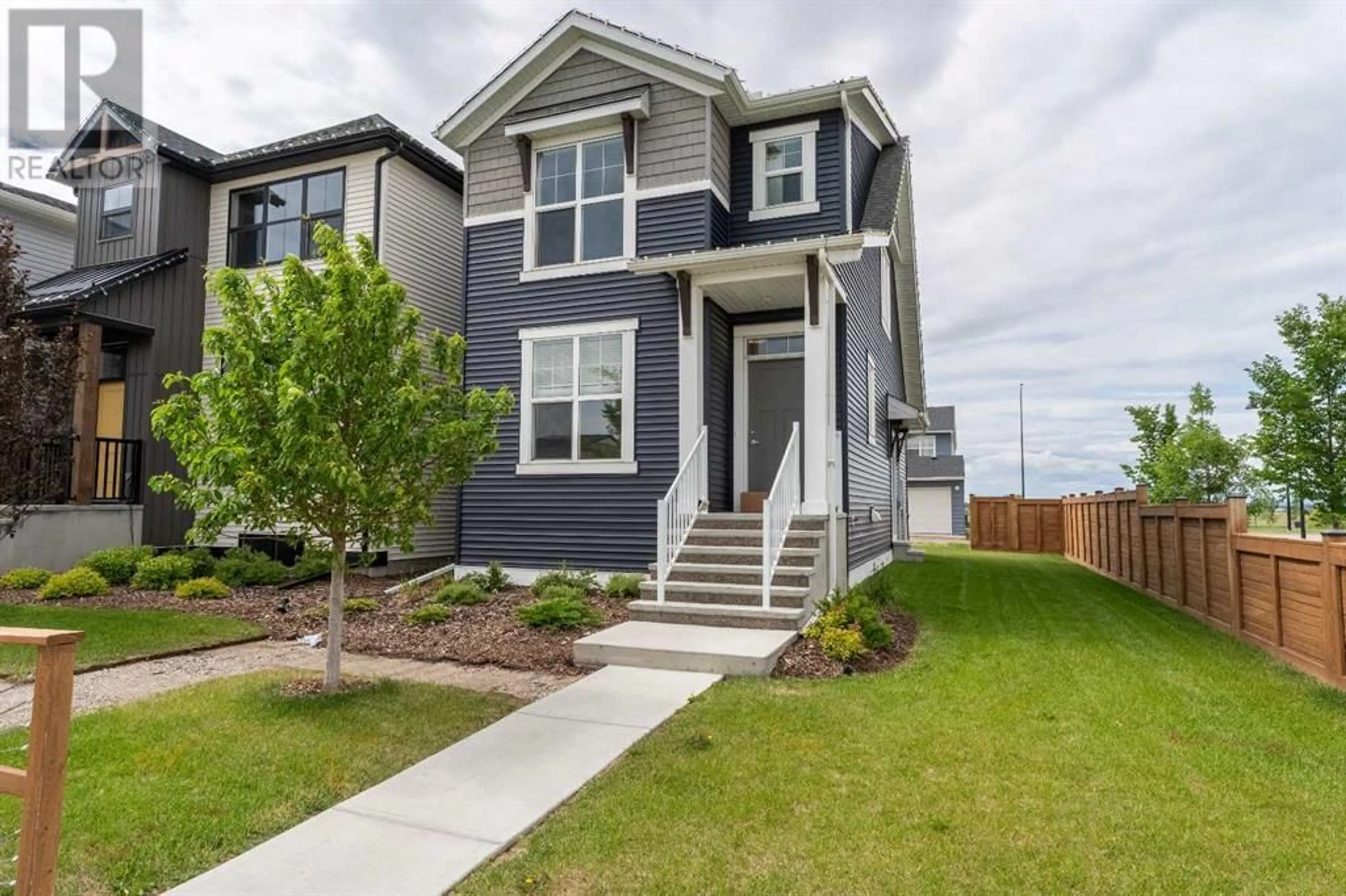Home with vinyl exterior material, street for 121 HOTCHKISS WAY SOUTHEAST, Calgary Alberta T3S0G3