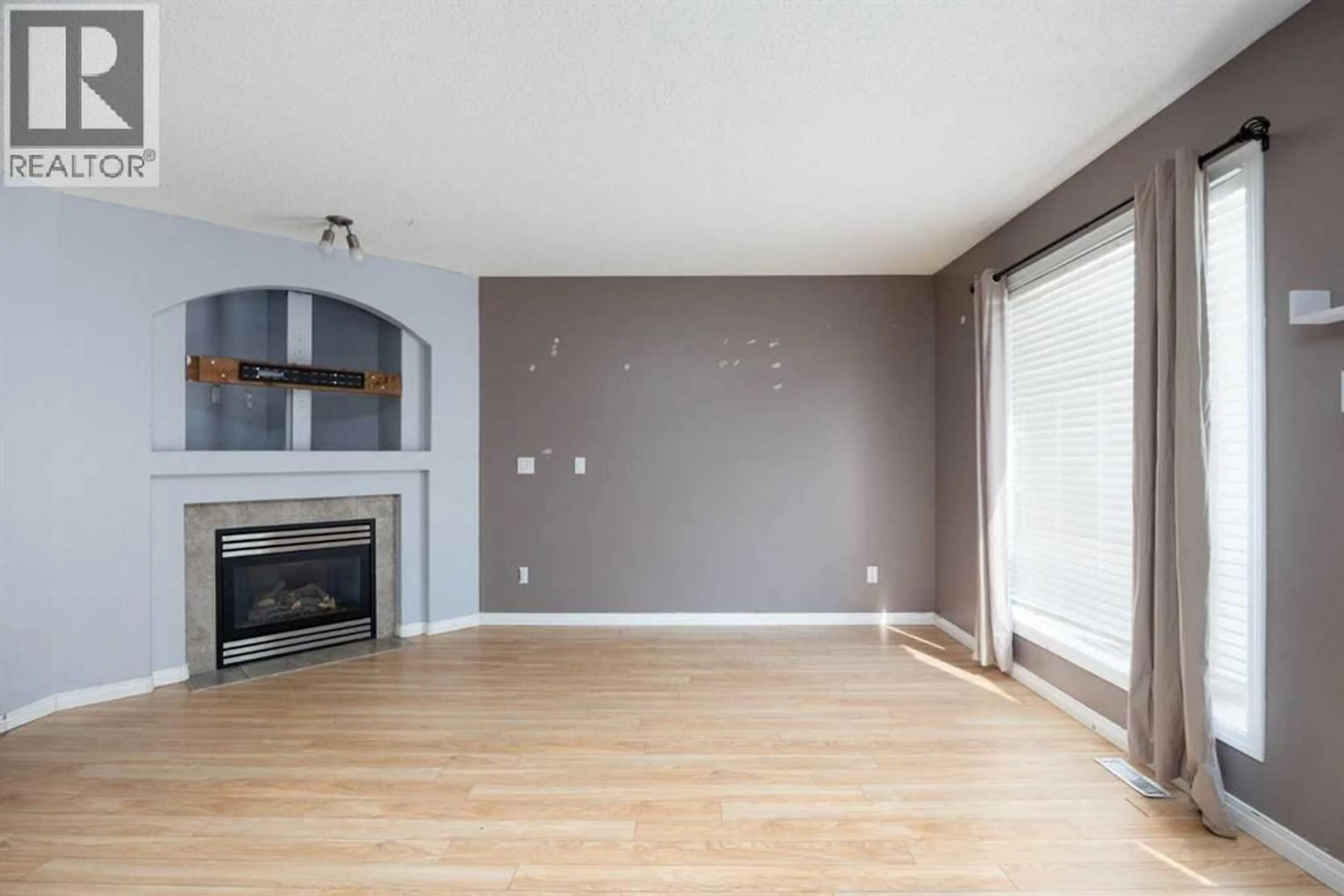 Living room with furniture, wood/laminate floor for 287 BEAR PAW DRIVE, Fort McMurray Alberta T9K2W1