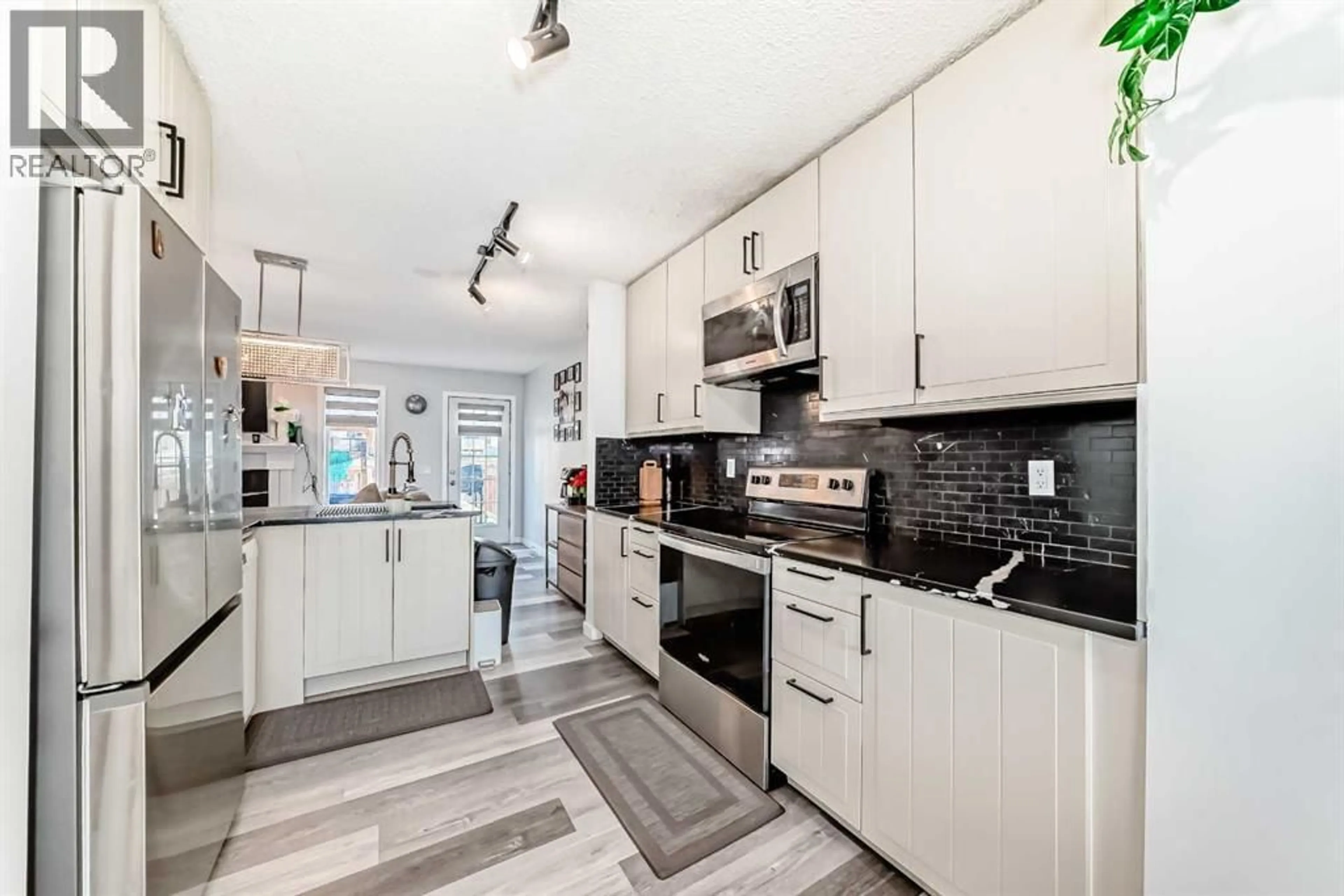 Open concept kitchen, ceramic/tile floor for 85 HIDDEN RANCH HILL NORTHWEST, Calgary Alberta T3A5X7