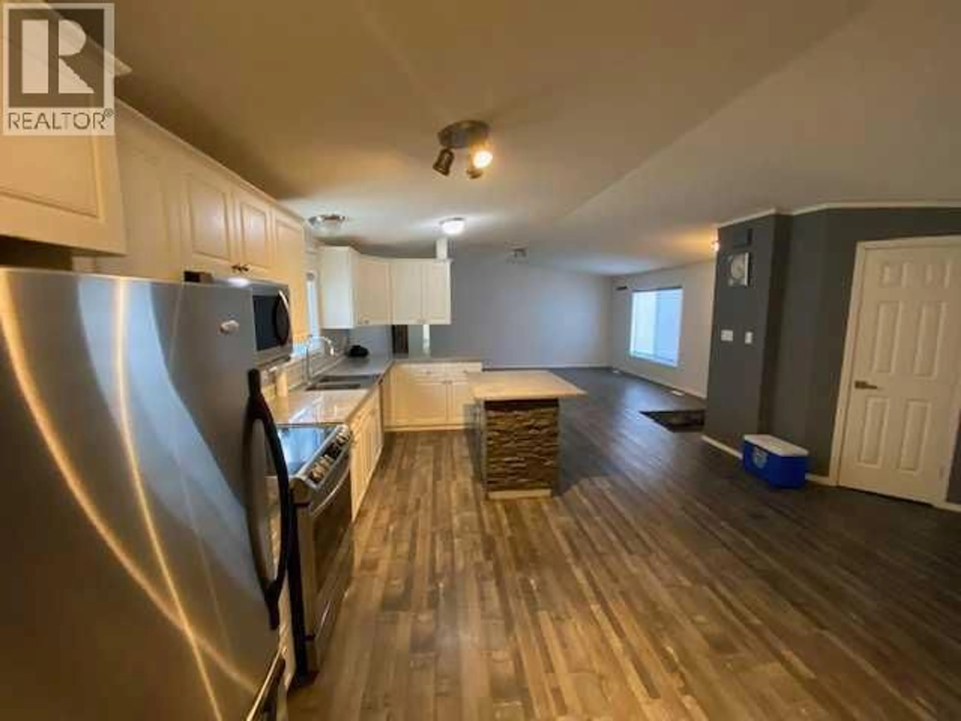 Open concept kitchen, wood/laminate floor for 7928 97 AVENUE, Peace River Alberta T8S1W6
