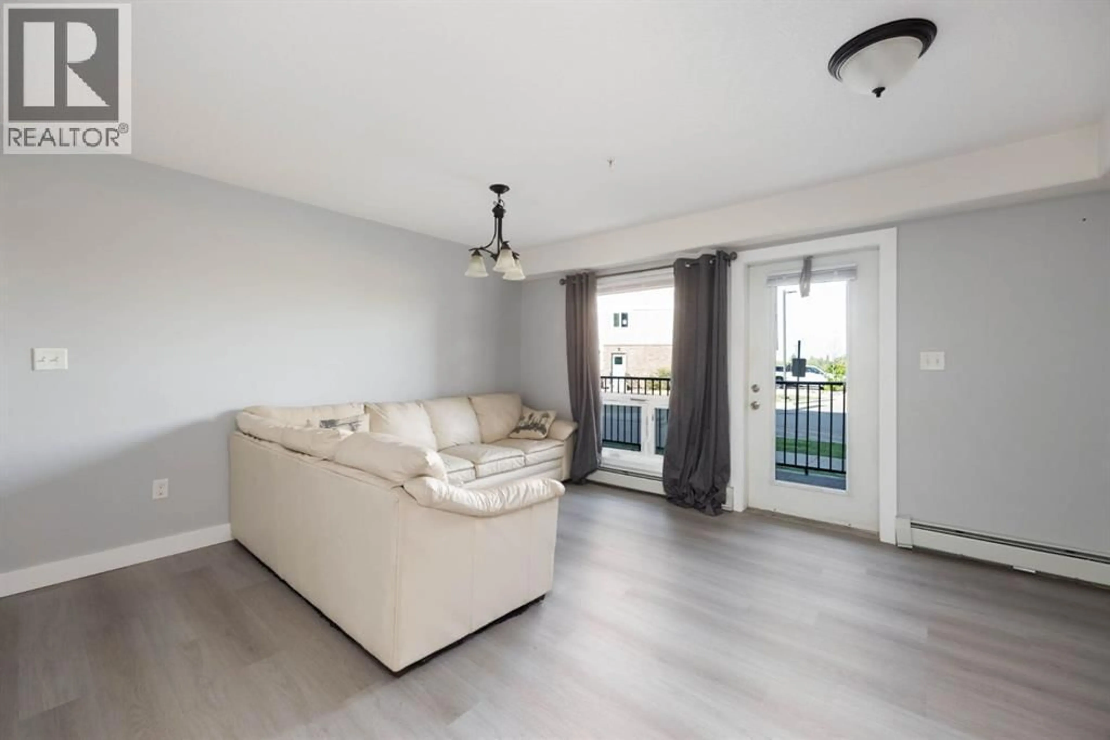 Living room with furniture, wood/laminate floor for 248 GROSBEAK WAY, Fort McMurray Alberta T9K0V9