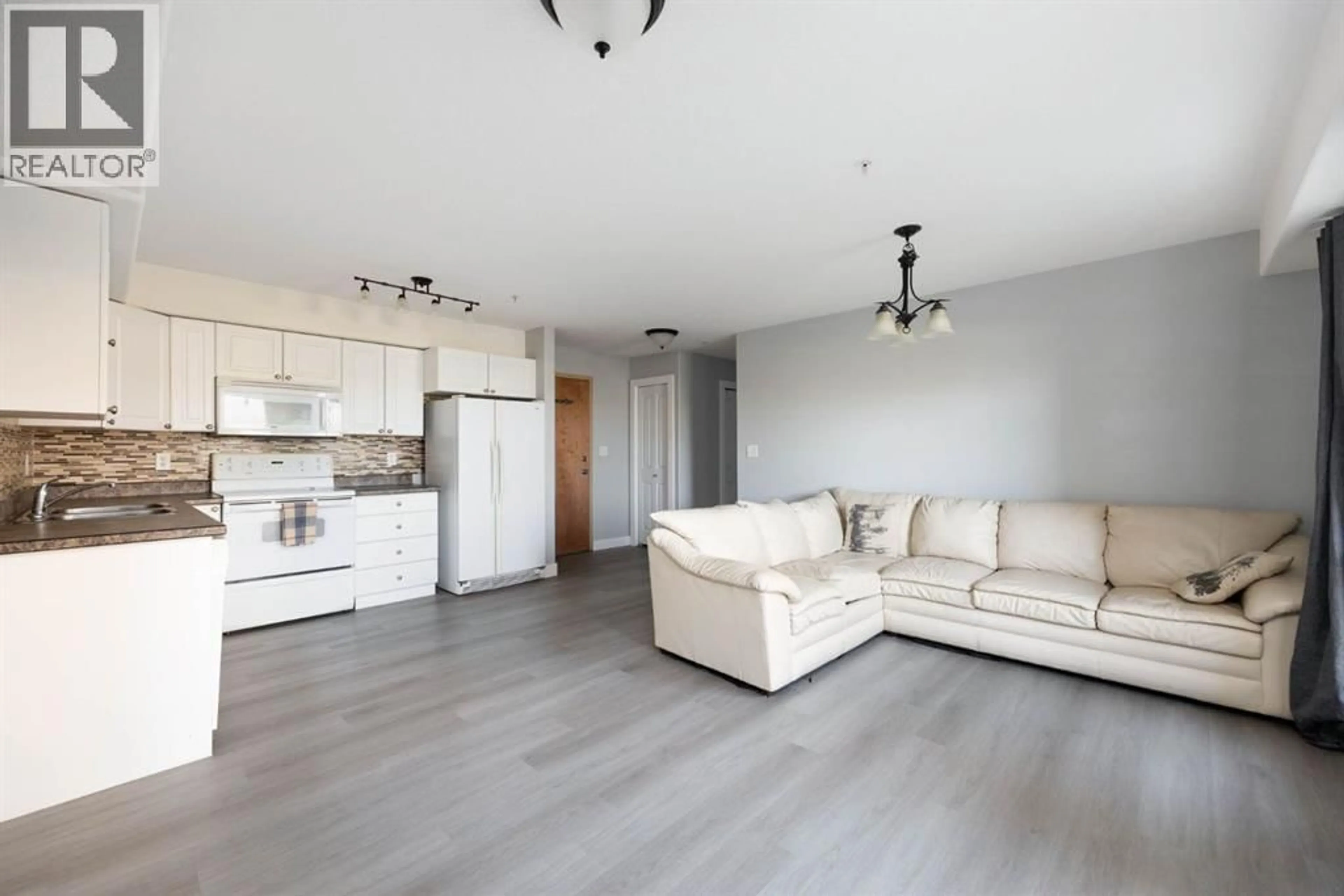Living room with furniture, wood/laminate floor for 248 GROSBEAK WAY, Fort McMurray Alberta T9K0V9