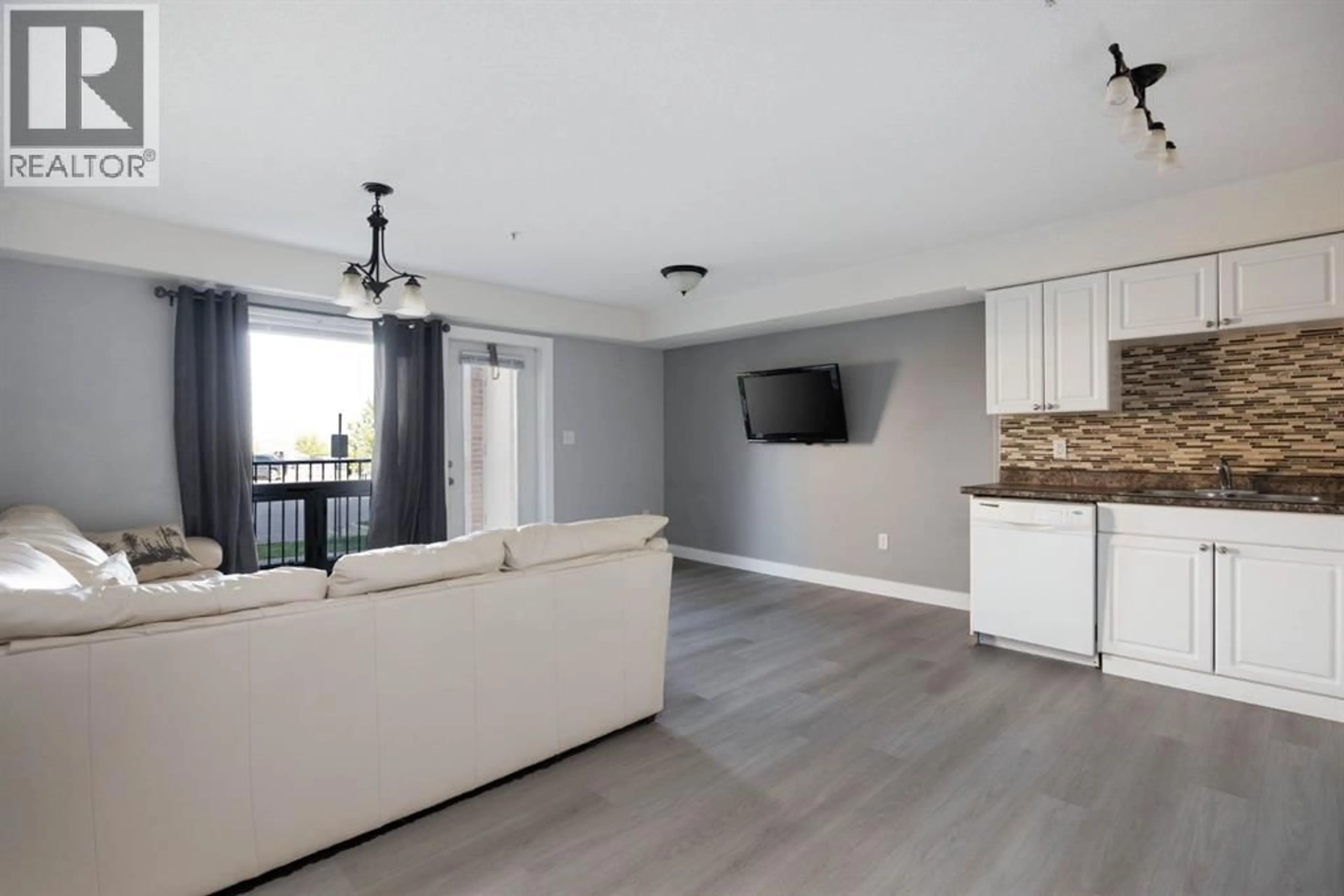 Living room with furniture, wood/laminate floor for 248 GROSBEAK WAY, Fort McMurray Alberta T9K0V9