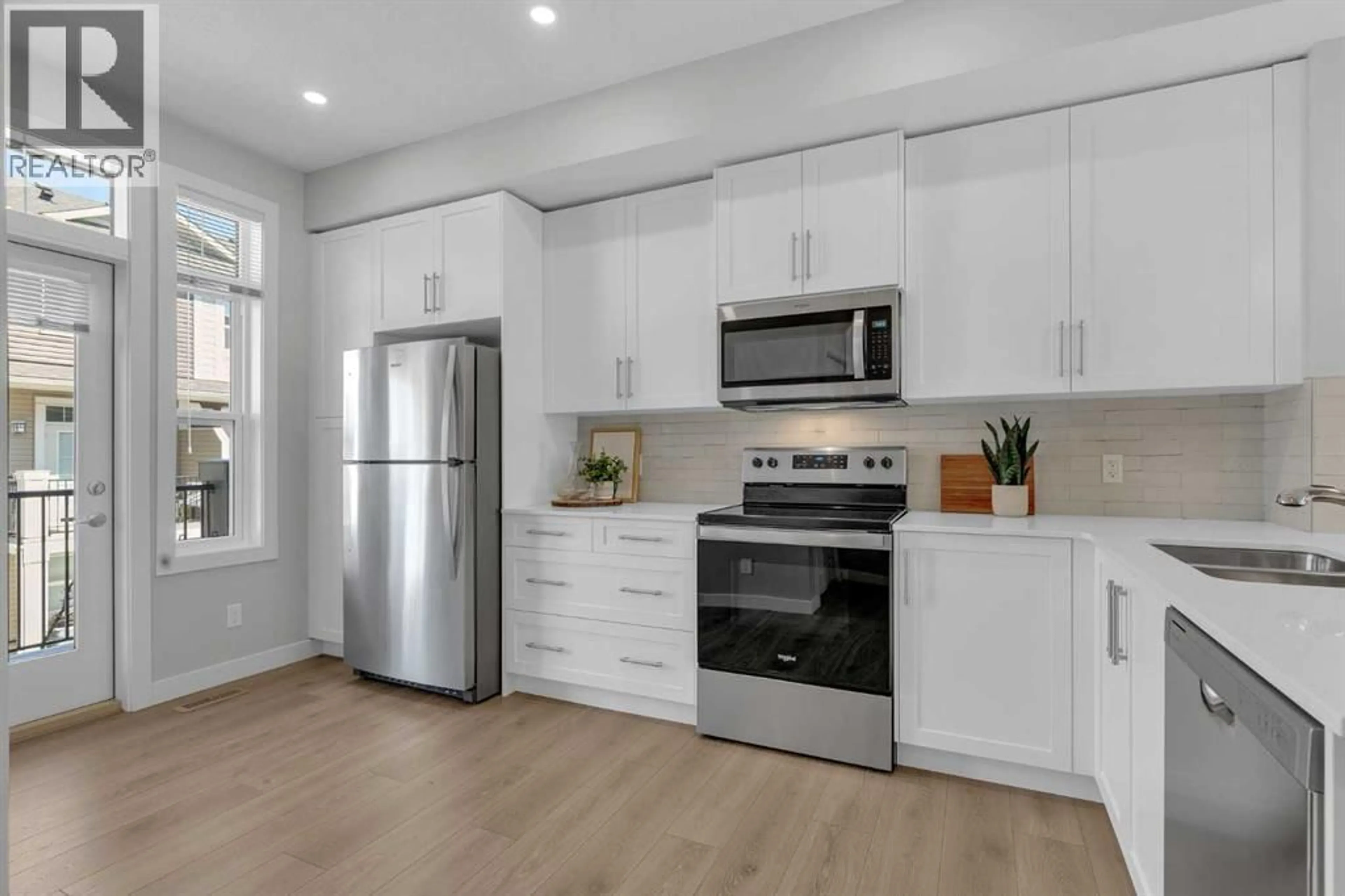 Open concept kitchen, wood/laminate floor for 118 LEGACY PATH SOUTHEAST, Calgary Alberta T2X4H9