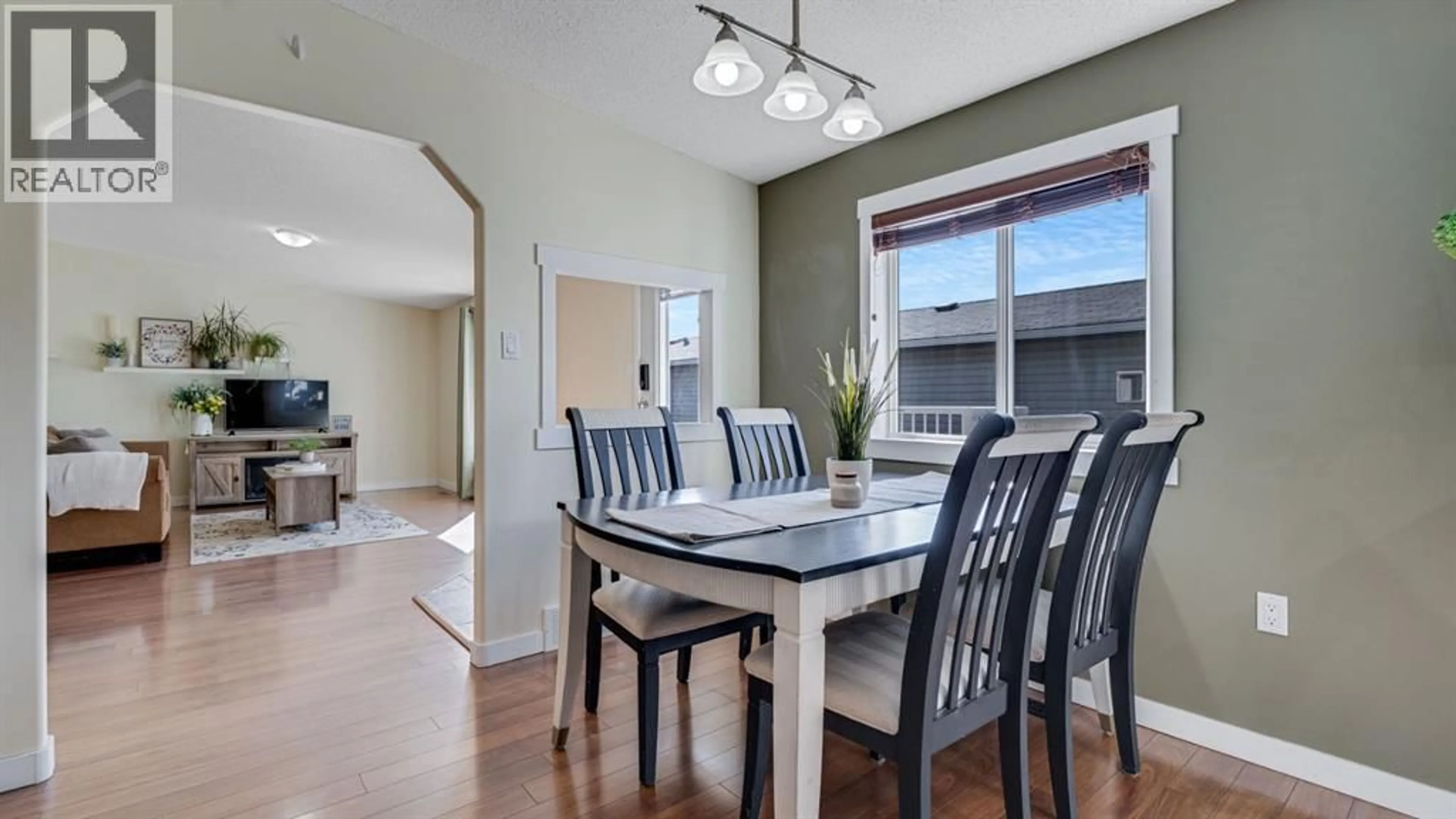 Dining room, wood/laminate floor for 156 MEADOWLARK LANE, Carstairs Alberta T0M0N0