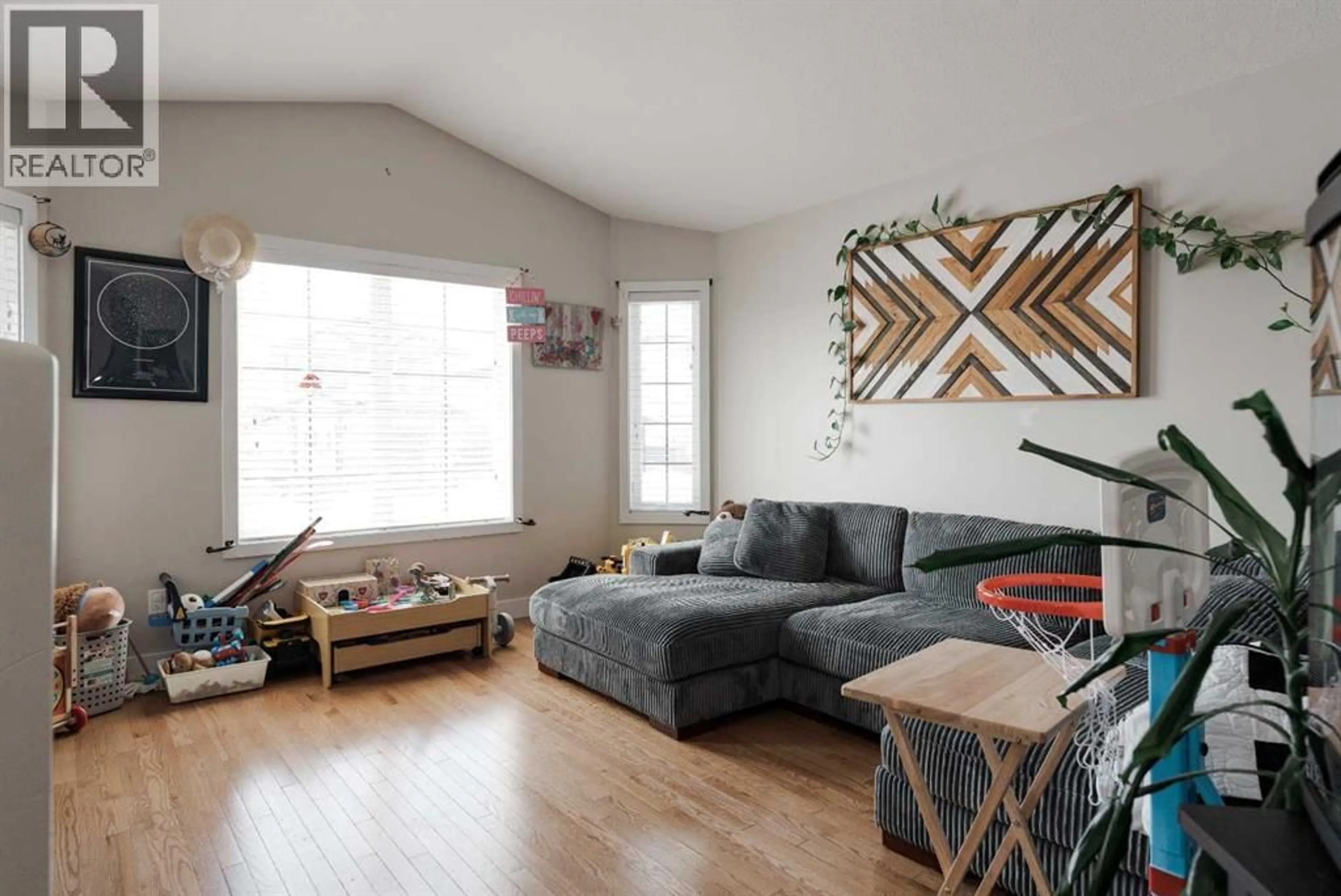 Living room with furniture, wood/laminate floor for 105 ELDERBERRY STREET, Fort McMurray Alberta T9K0N6