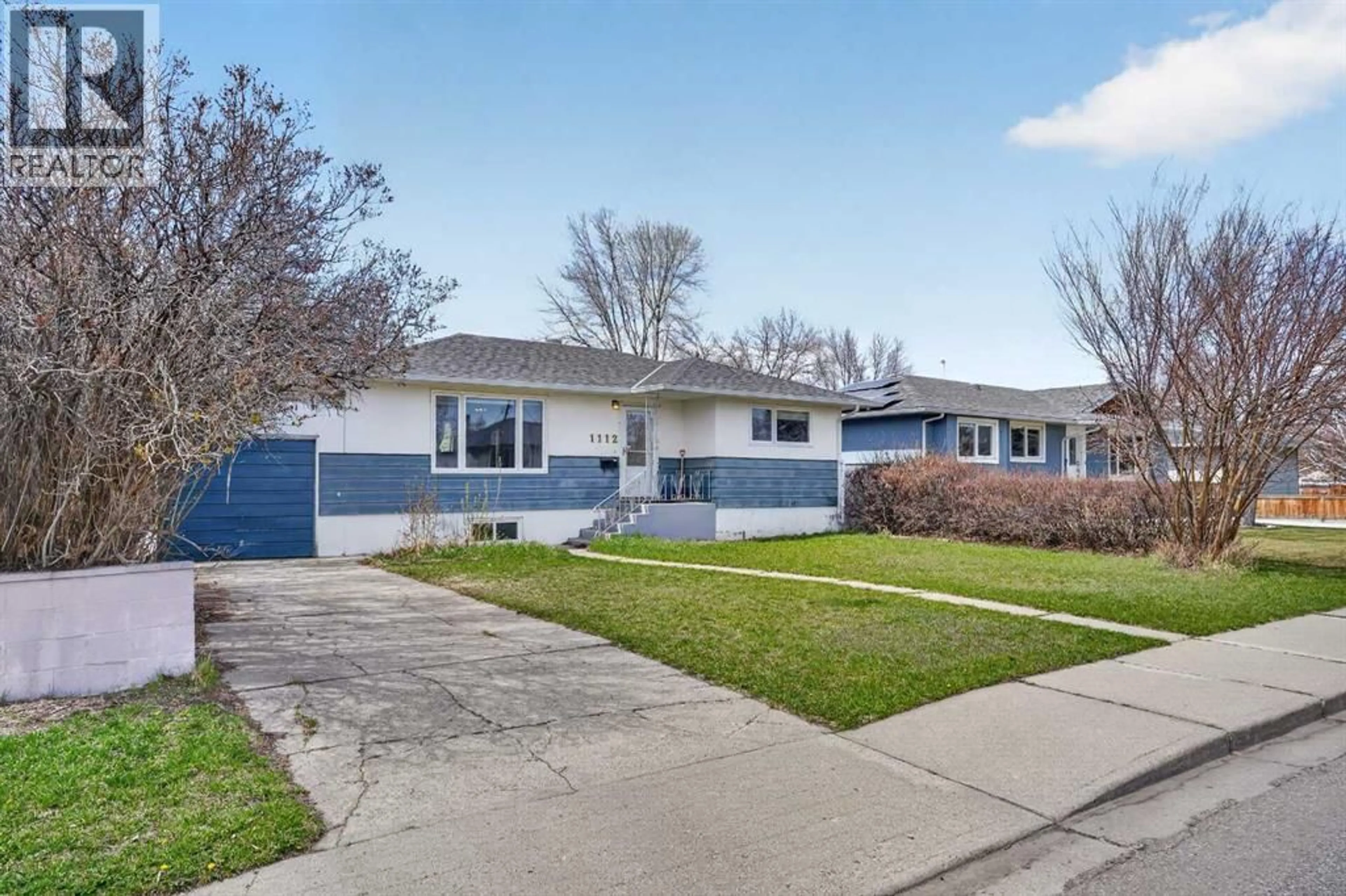 Home with vinyl exterior material, street for 1112 28A STREET SOUTH, Lethbridge Alberta T1K2W7