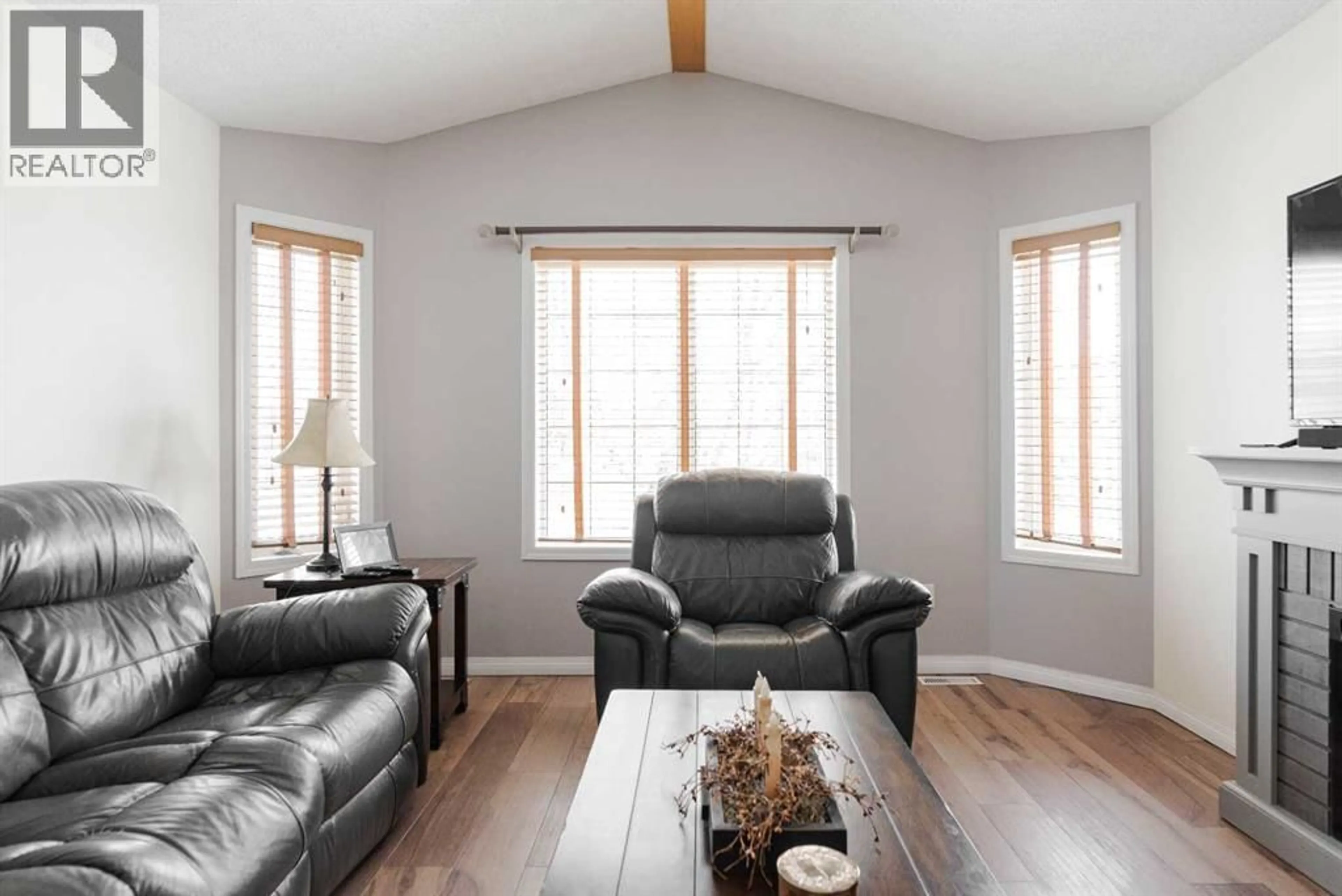 Living room with furniture, wood/laminate floor for 145 ARCHIBALD CLOSE, Fort McMurray Alberta T9K2P3