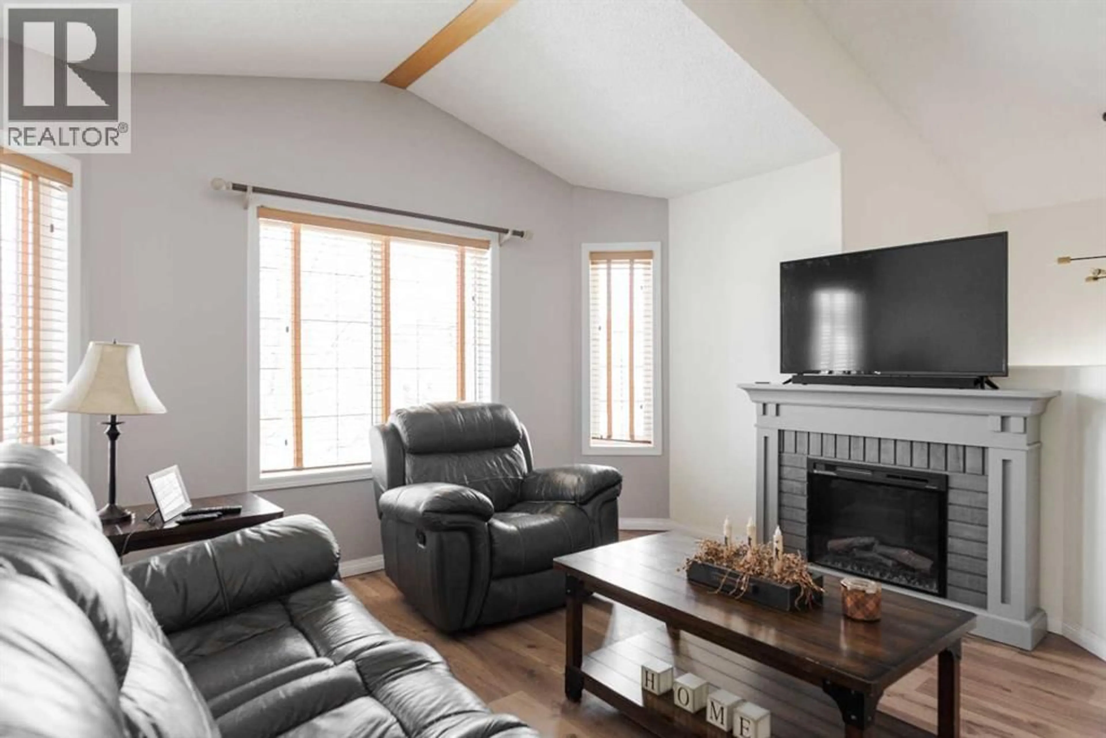 Living room with furniture, wood/laminate floor for 145 ARCHIBALD CLOSE, Fort McMurray Alberta T9K2P3