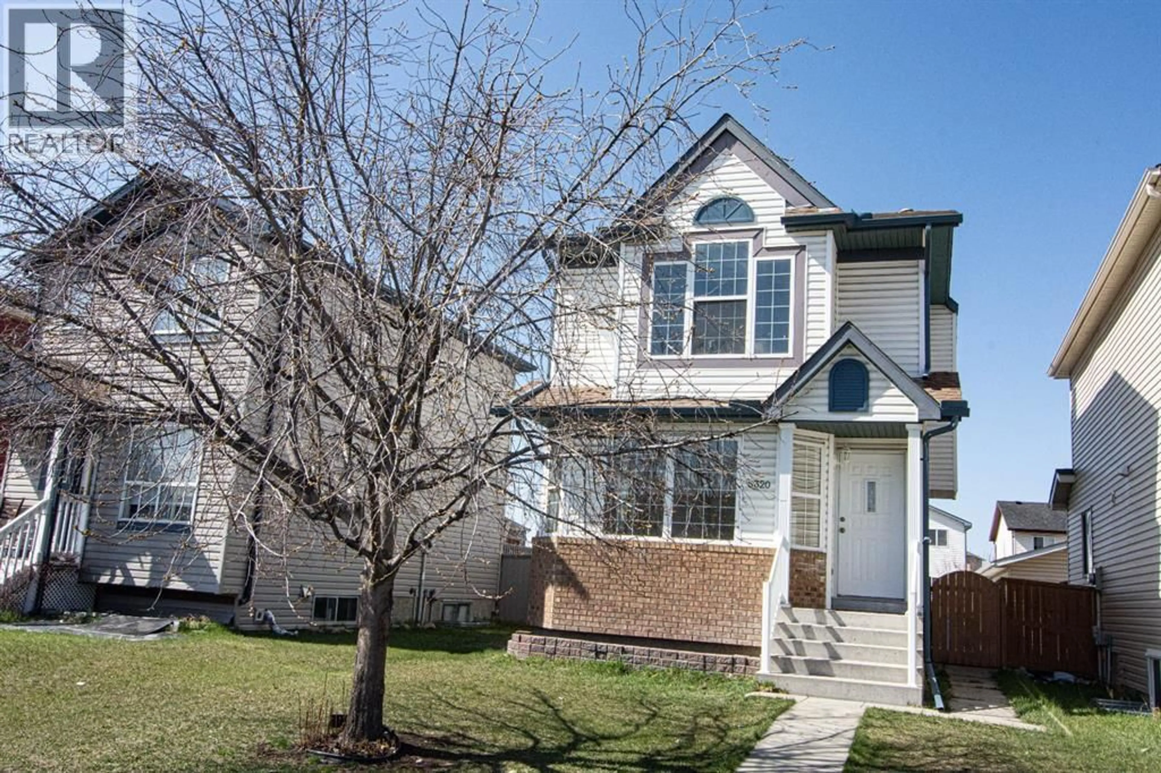 Home with vinyl exterior material, street for 5320 MARTIN CROSSING DRIVE NORTHEAST, Calgary Alberta T3J3T2