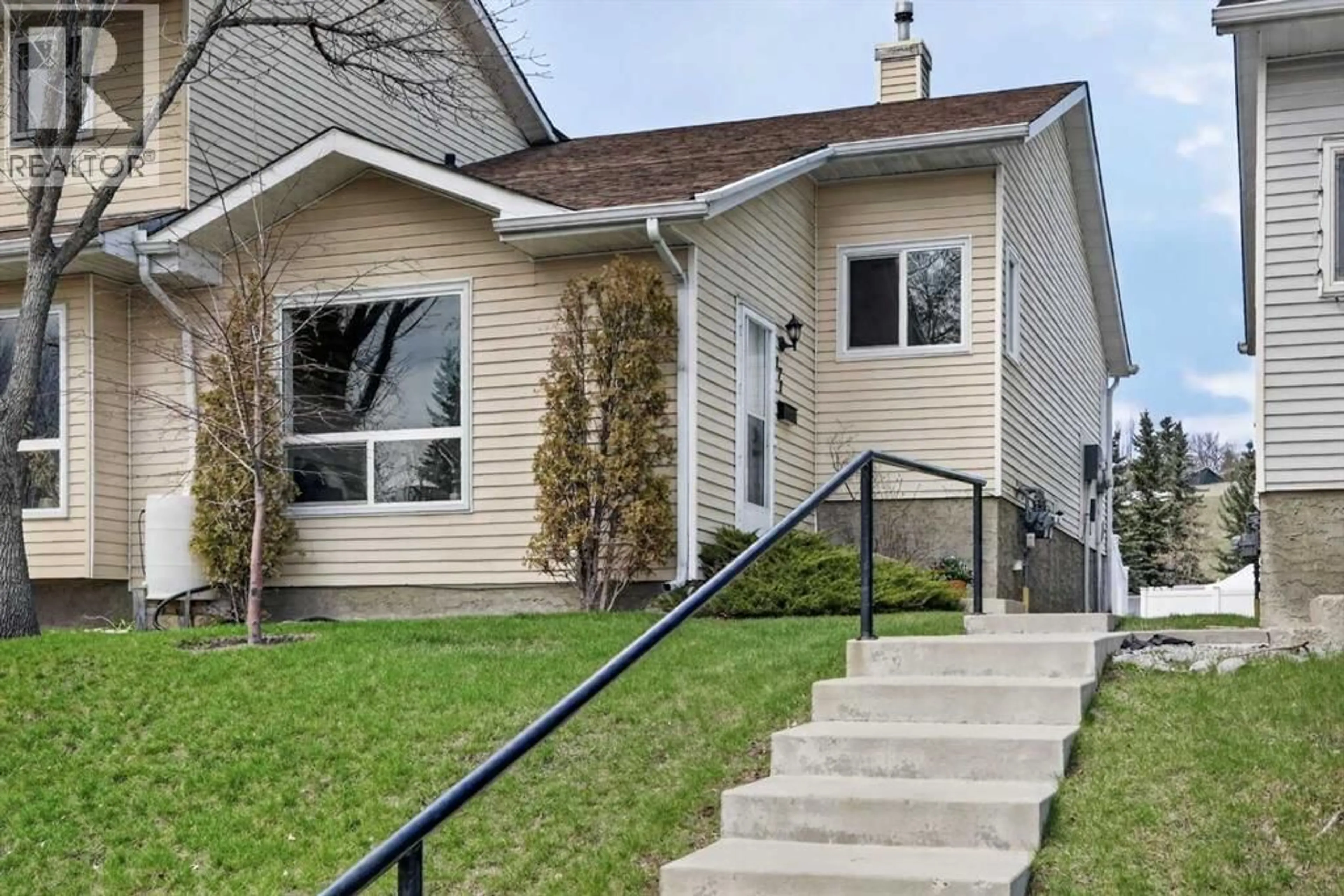 Home with vinyl exterior material, street for 171 DEERFIELD DRIVE SOUTHEAST, Calgary Alberta T2J7B7