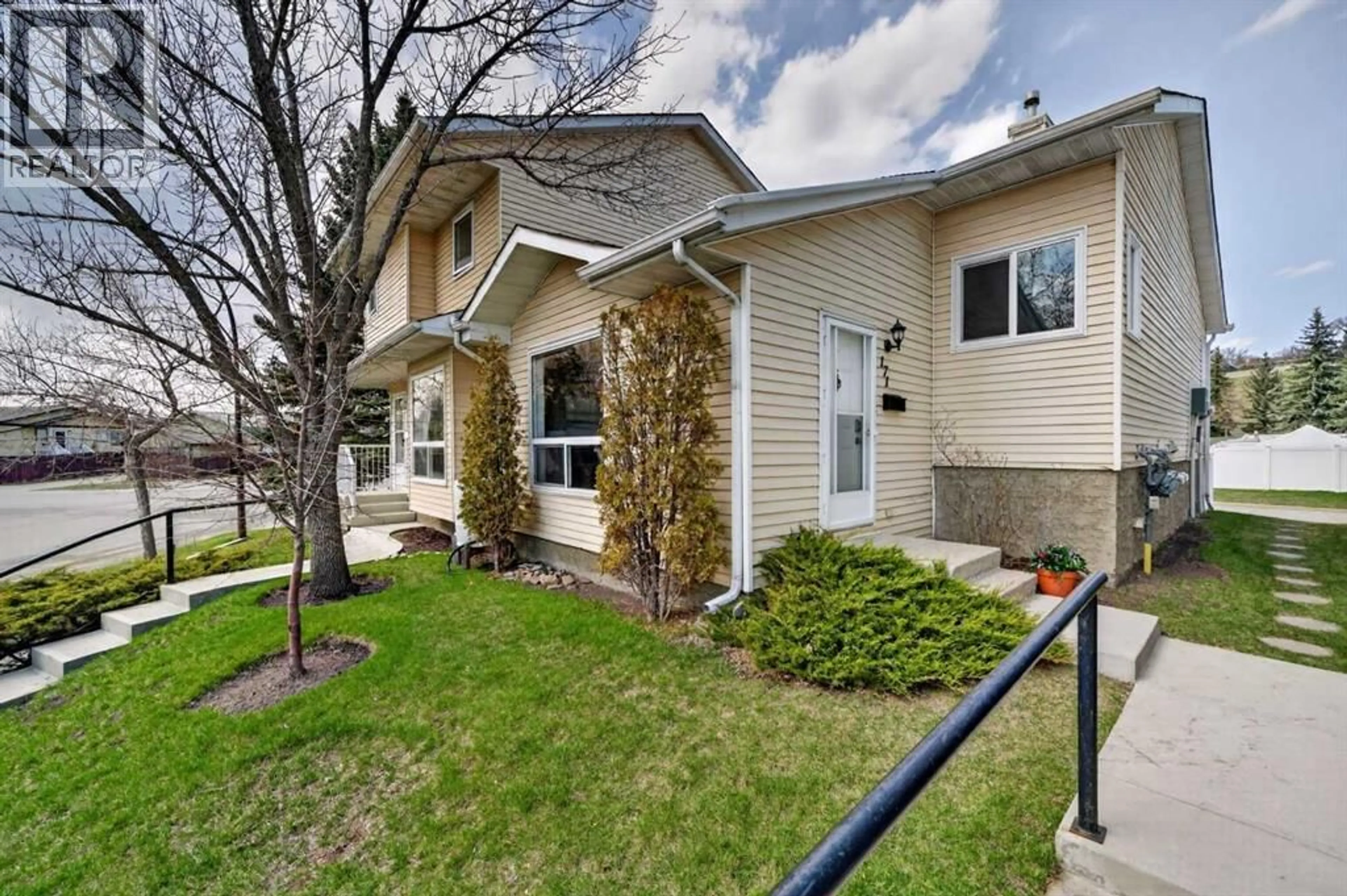 Home with vinyl exterior material, street for 171 DEERFIELD DRIVE SOUTHEAST, Calgary Alberta T2J7B7