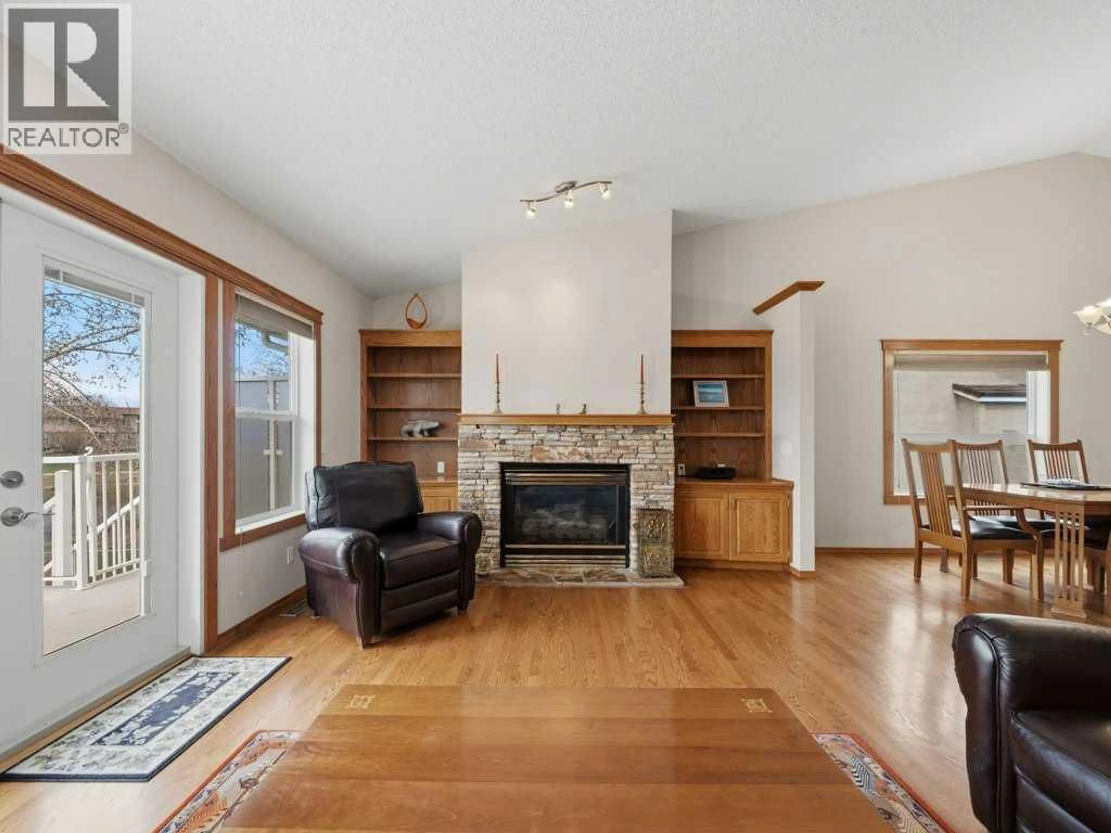 Living room with furniture, wood/laminate floor for 152 WATERSTONE PLACE SOUTHEAST, Airdrie Alberta T4B2G1