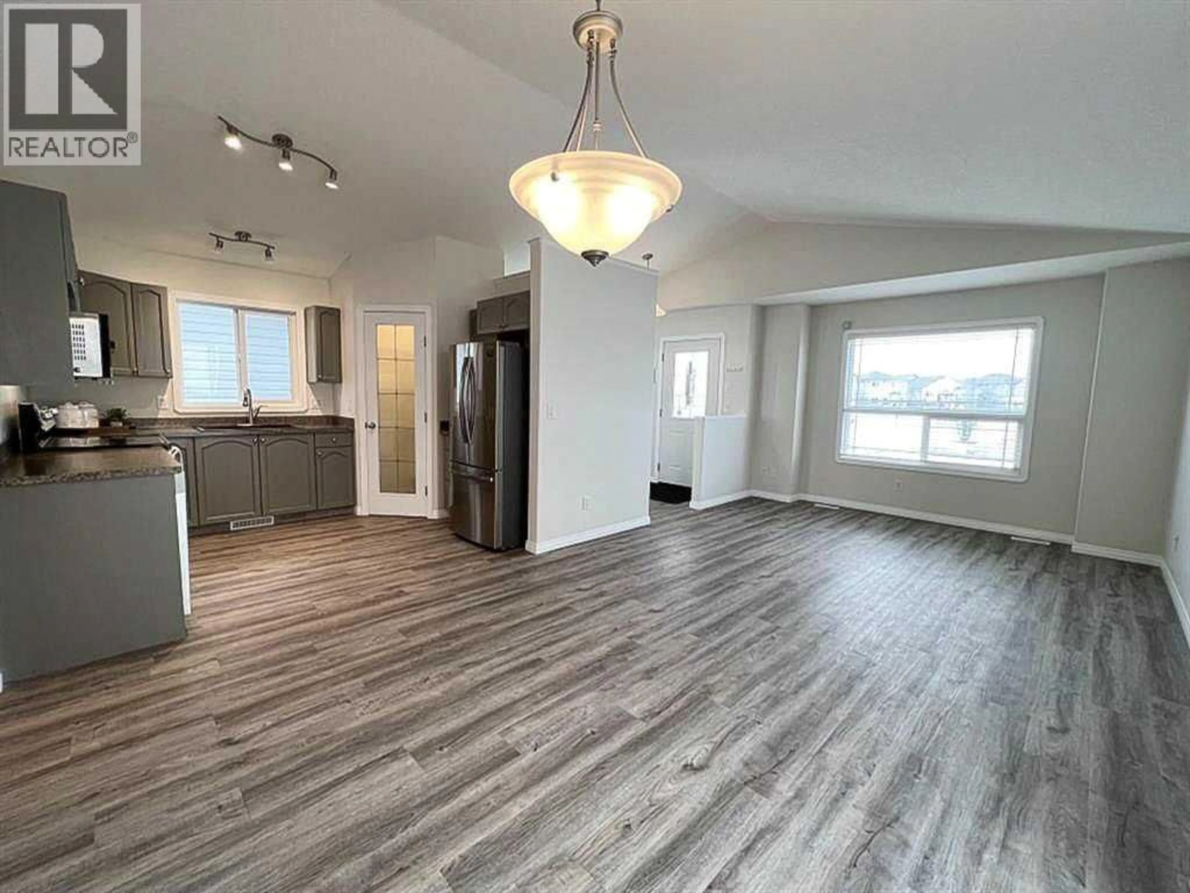 Open concept kitchen, wood/laminate floor for 11509 78 AVENUE, Grande Prairie Alberta T8W0A2