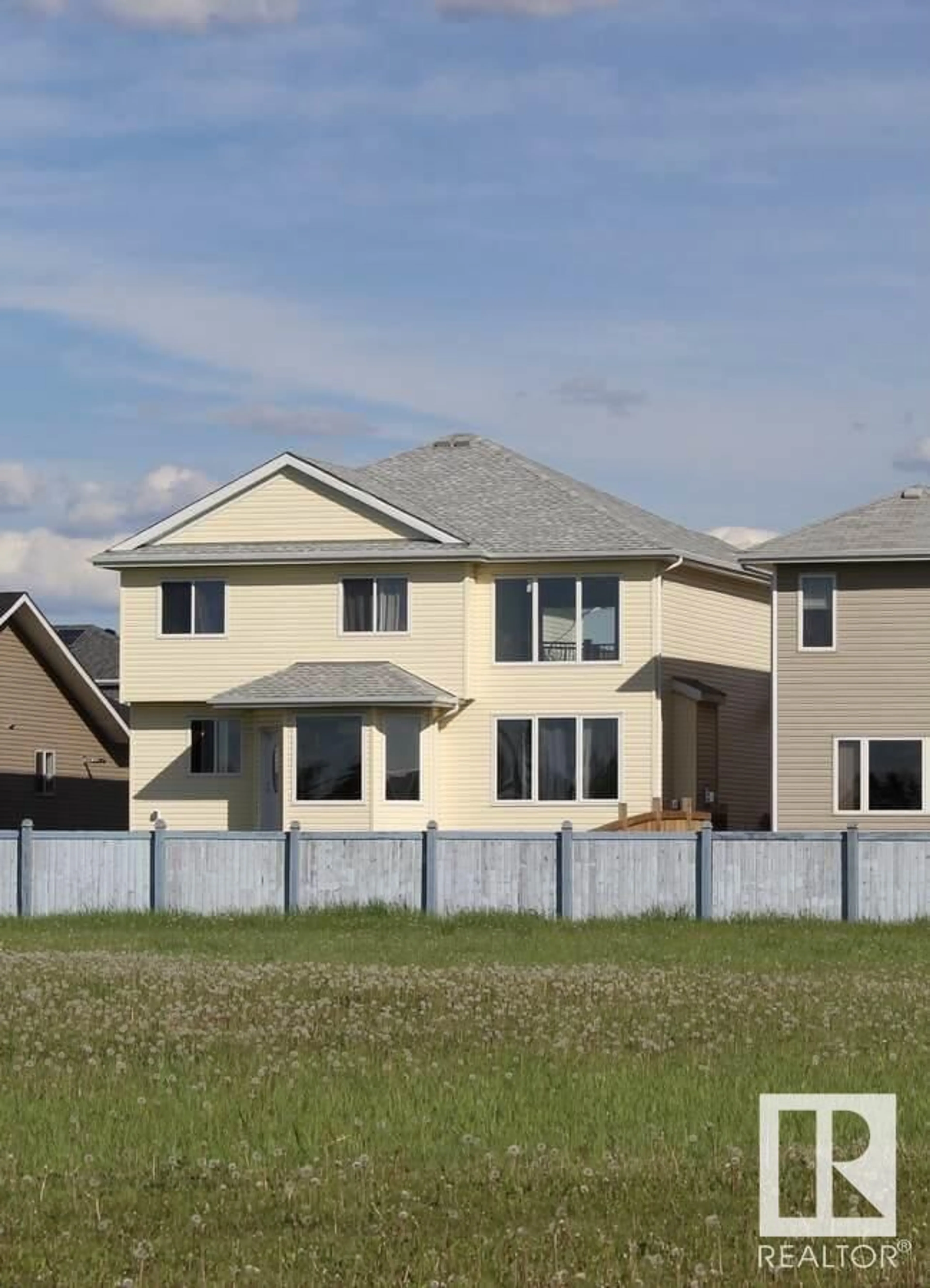 Frontside or backside of a home, the fenced backyard for 128 Houle DR, Morinville Alberta T8R0E1