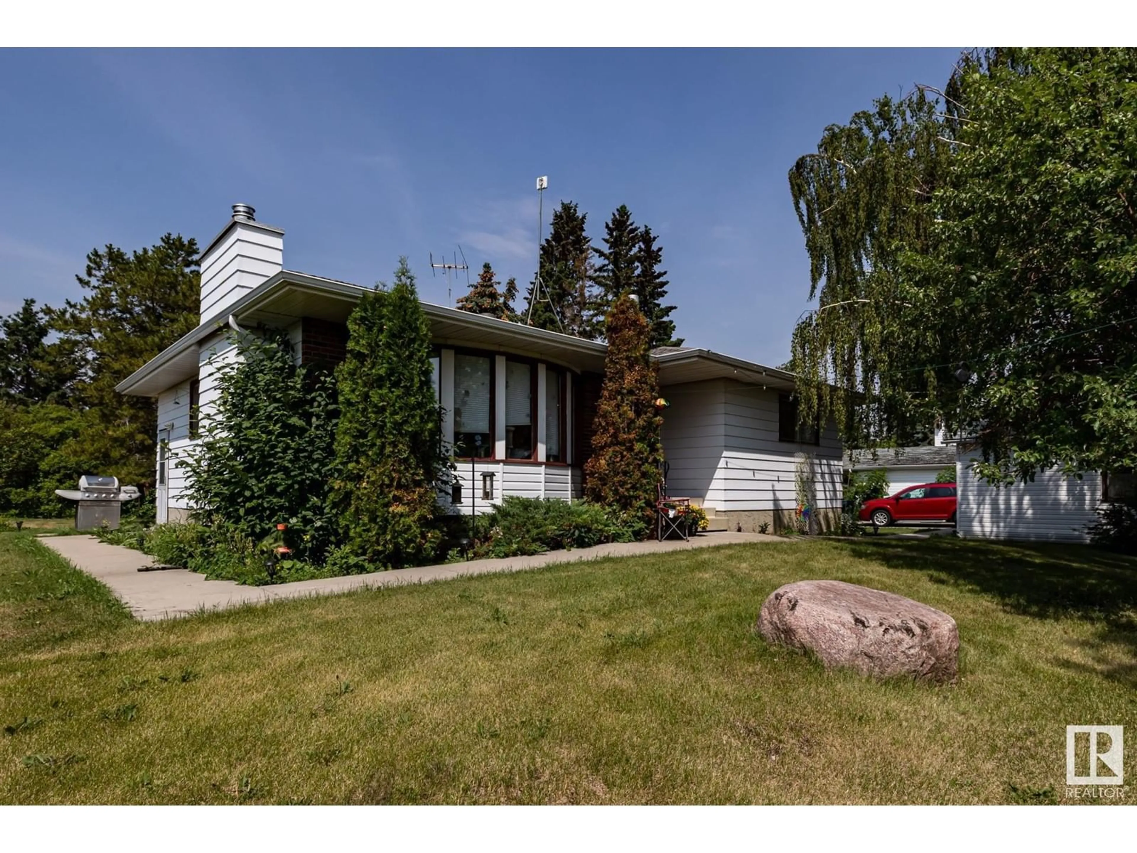 Home with vinyl exterior material, street for 20469 HWY 15, Rural Strathcona County Alberta T8L4B1