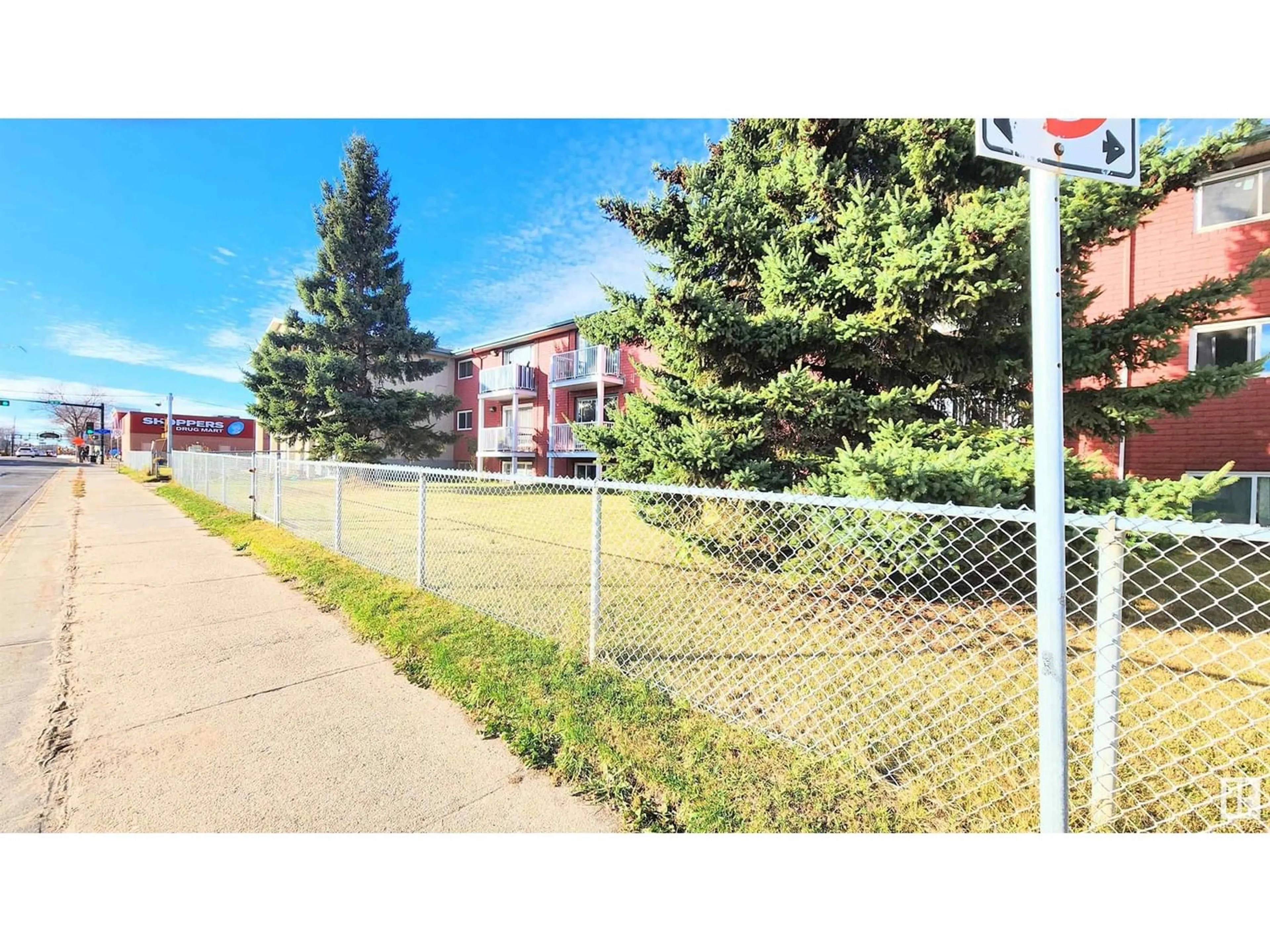 A pic from exterior of the house or condo, the fenced backyard for #308 3720 118 AV NW, Edmonton Alberta T5M0Z6