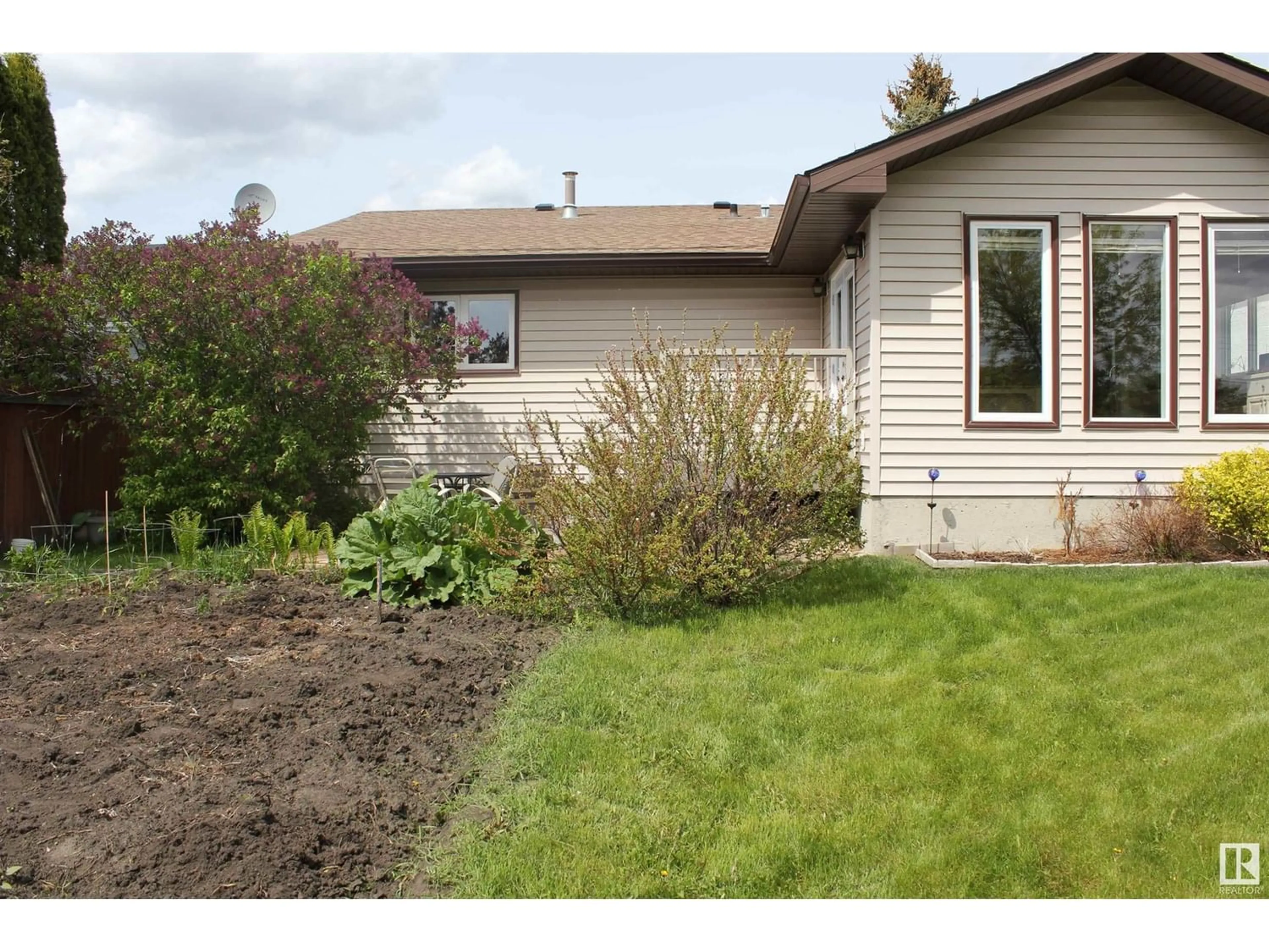 Frontside or backside of a home, the fenced backyard for 5117 58 AV, Elk Point Alberta T0A1A0