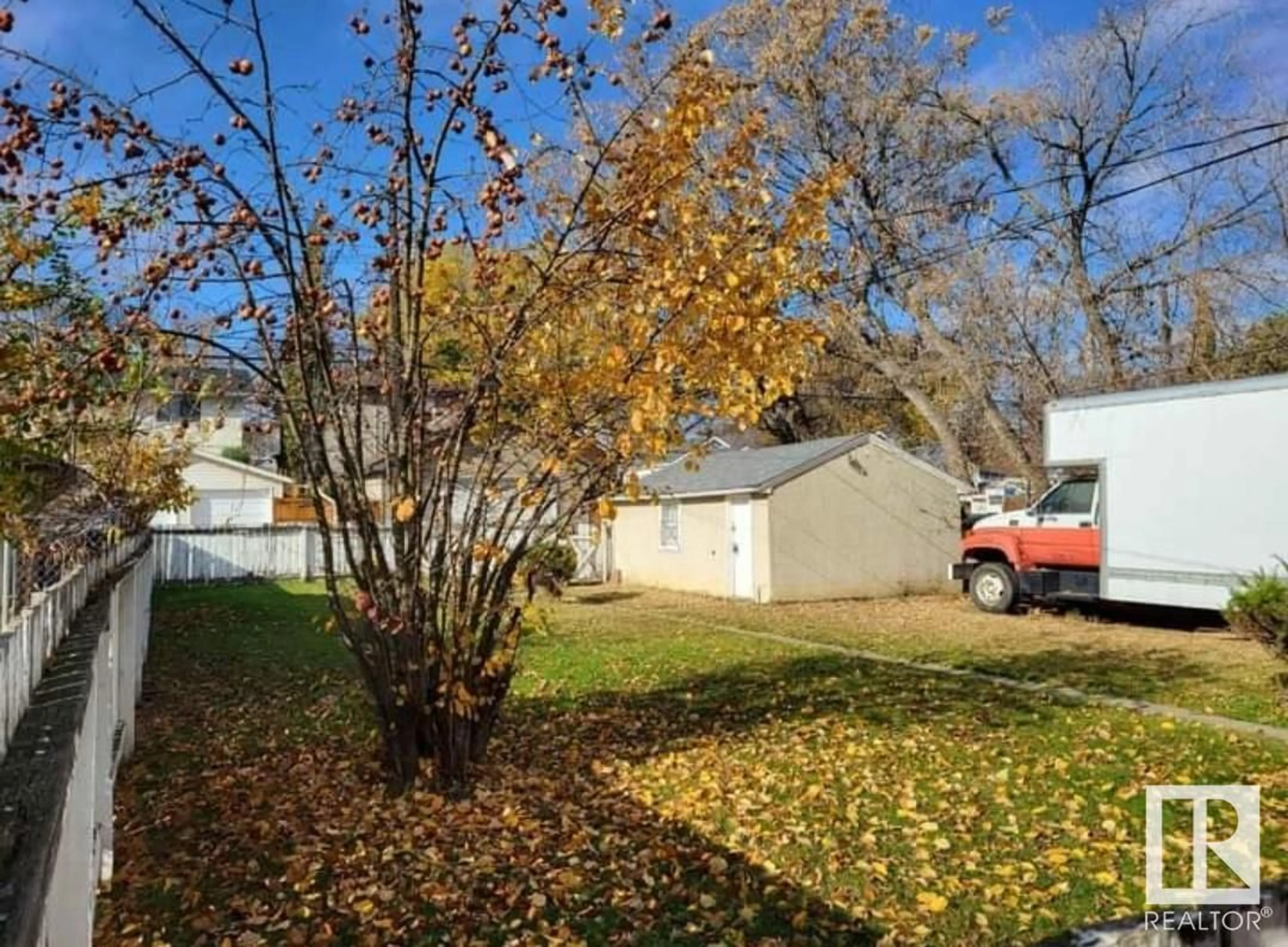 A pic from exterior of the house or condo, the fenced backyard for 11932 62 ST NW, Edmonton Alberta T5W4C6