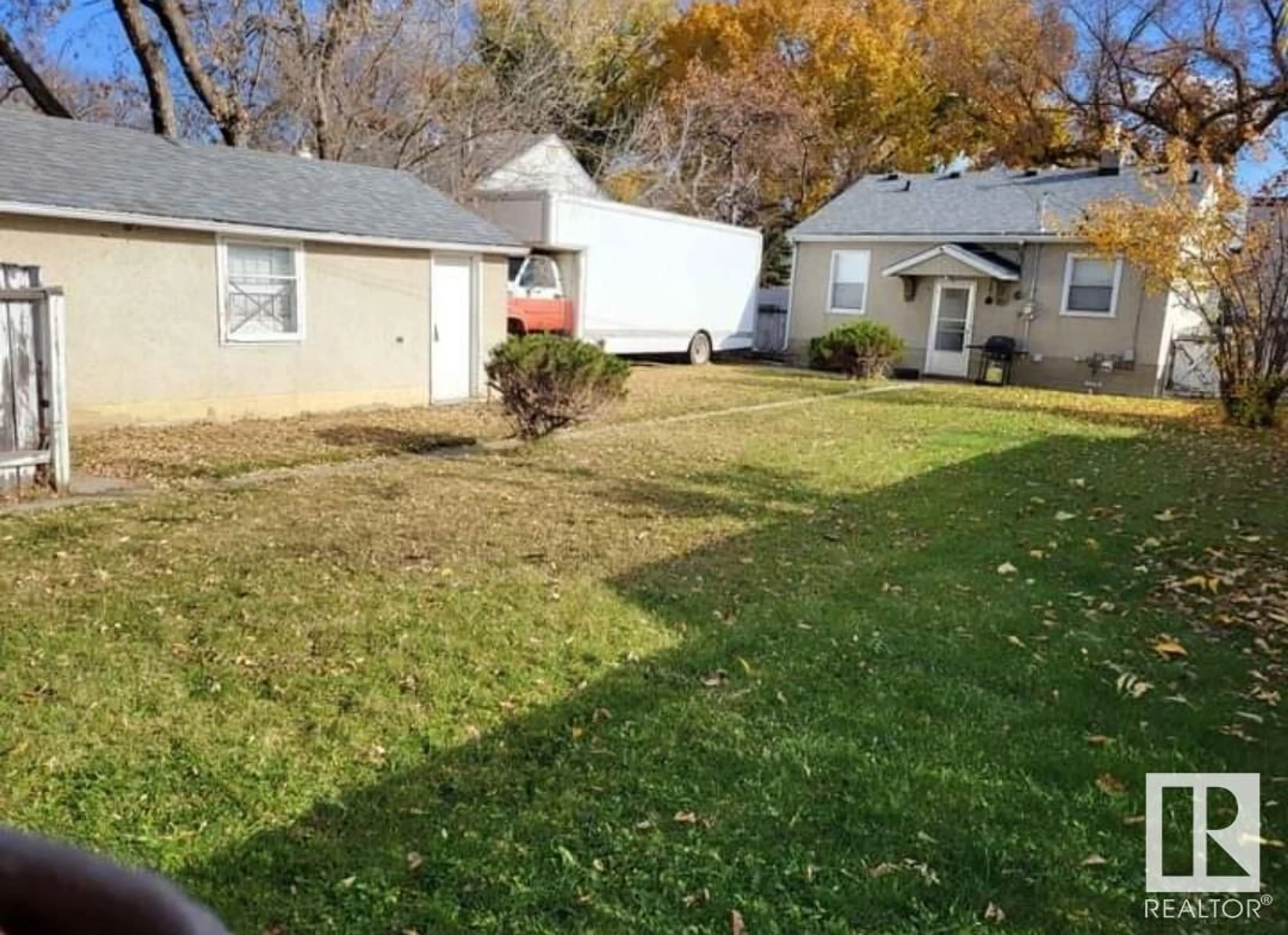 Frontside or backside of a home, the fenced backyard for 11932 62 ST NW, Edmonton Alberta T5W4C6