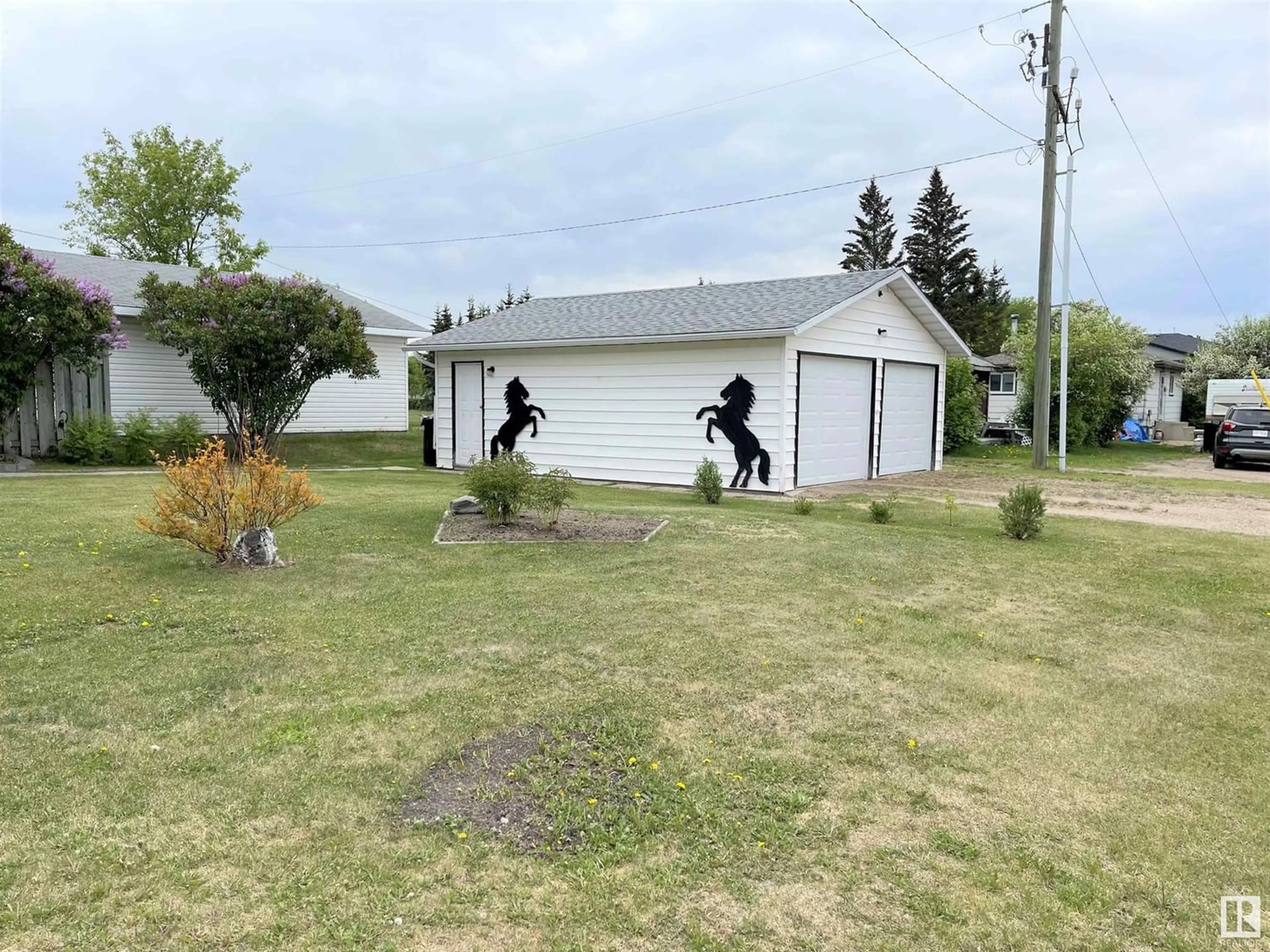 Frontside or backside of a home, the fenced backyard for 4902 51 AV, Ardmore Alberta T0A0B0