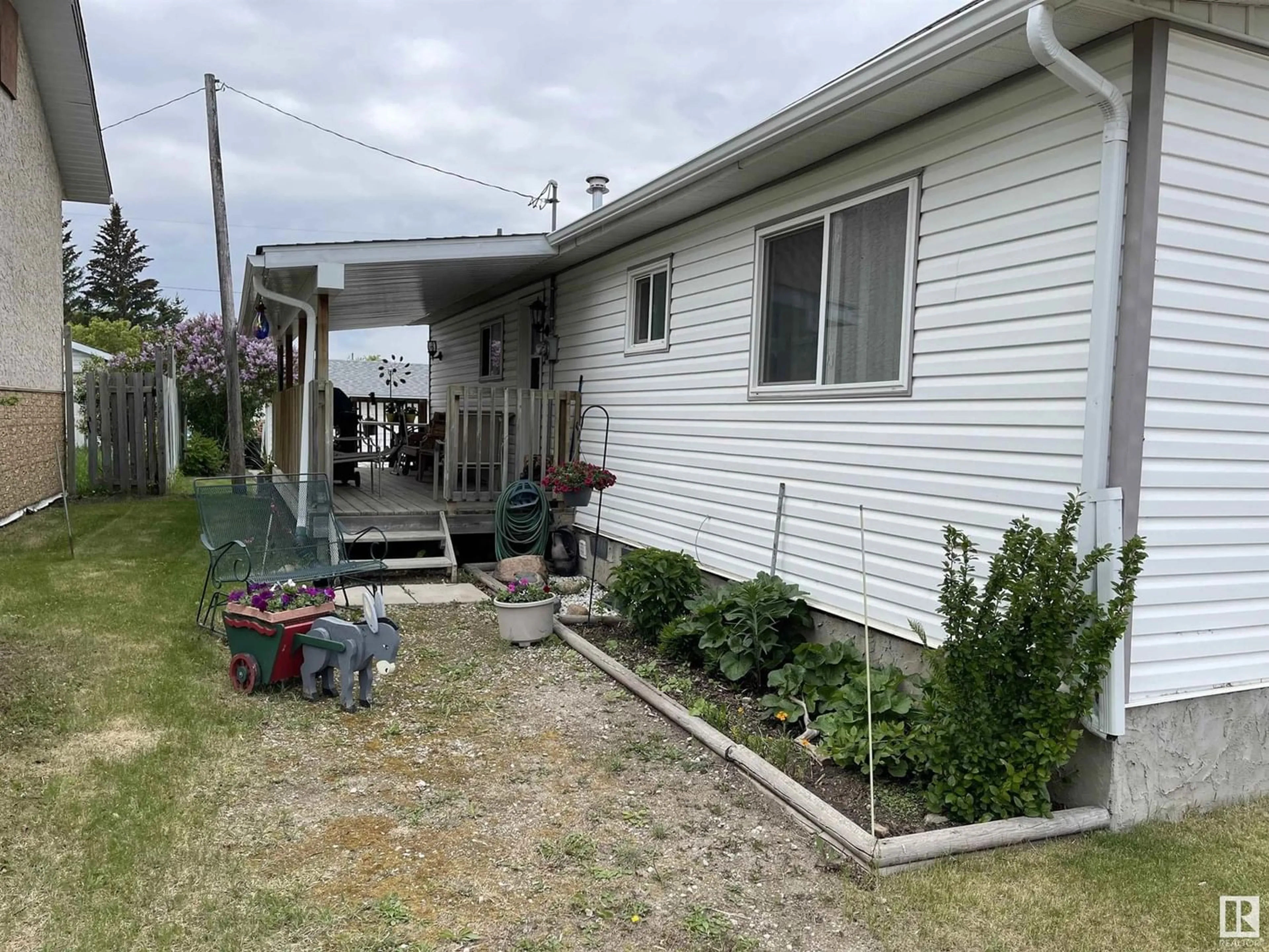 Frontside or backside of a home, the fenced backyard for 4902 51 AV, Ardmore Alberta T0A0B0