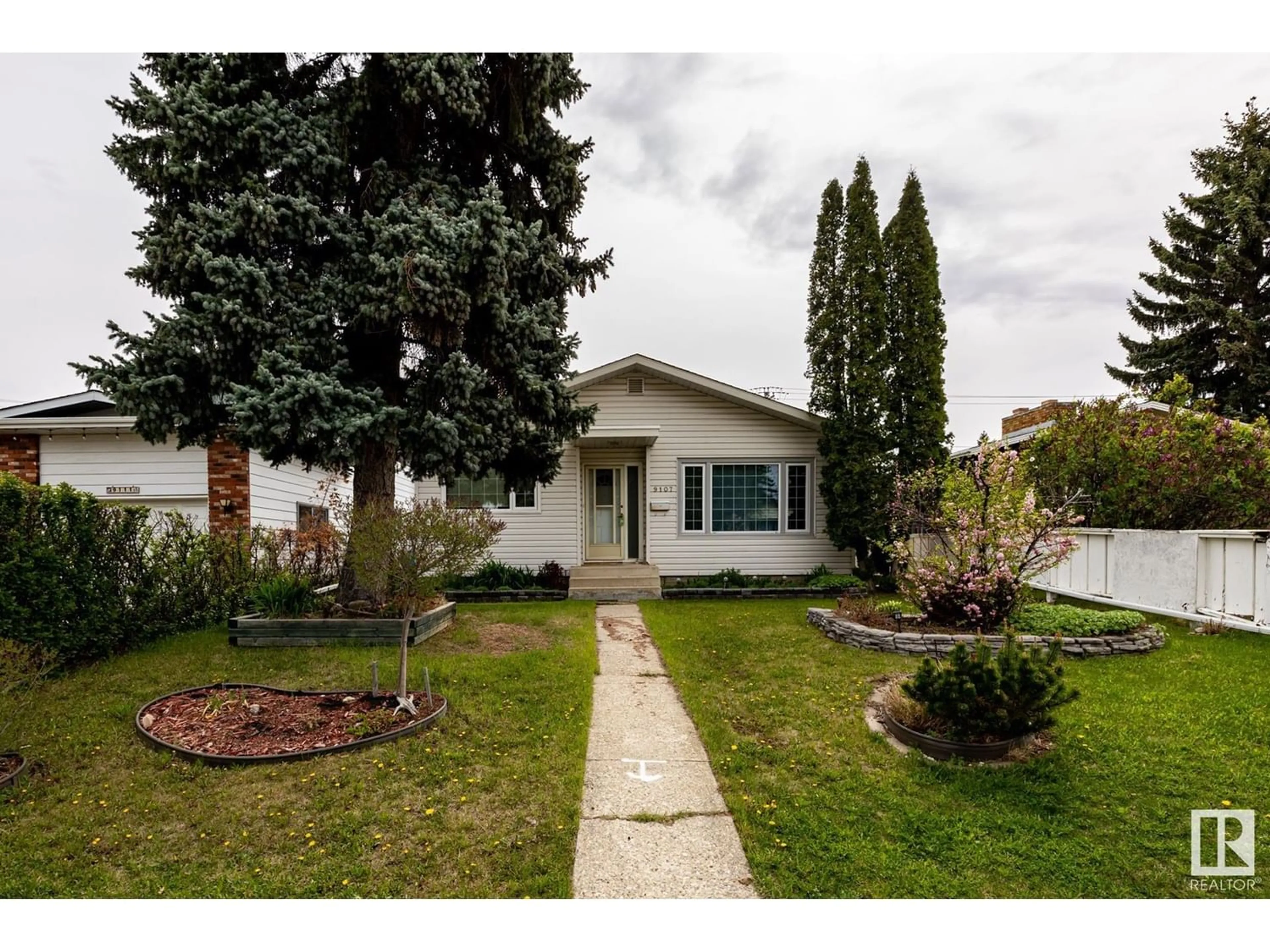 Frontside or backside of a home for 9107 74 ST NW, Edmonton Alberta T6B2B3