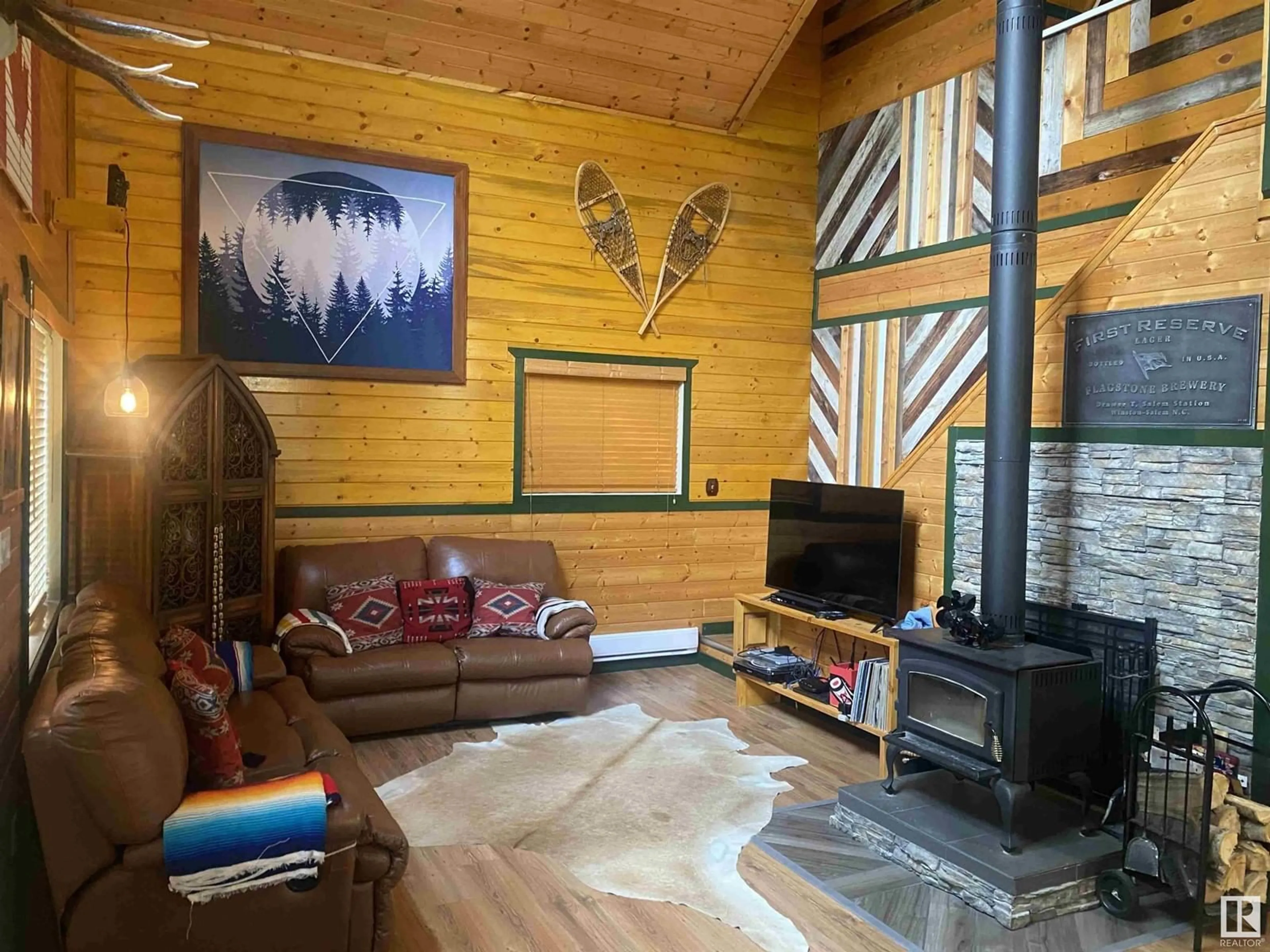 Living room with furniture, wood/laminate floor for 410 55061 TWP RD 462, Rural Wetaskiwin County Alberta T0C0T0