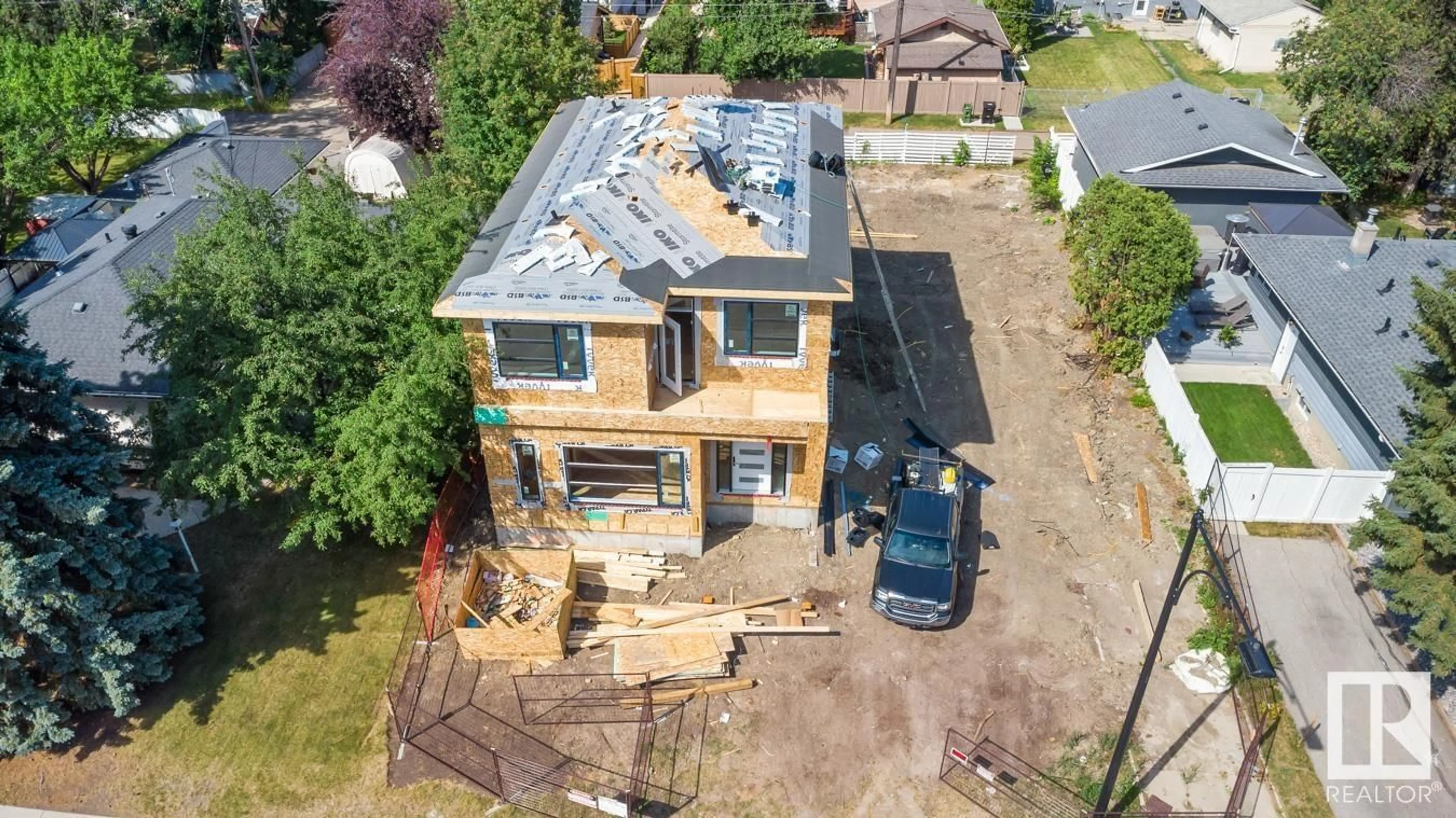 Frontside or backside of a home, the fenced backyard for 8504 148 ST NW, Edmonton Alberta T5R0Z6