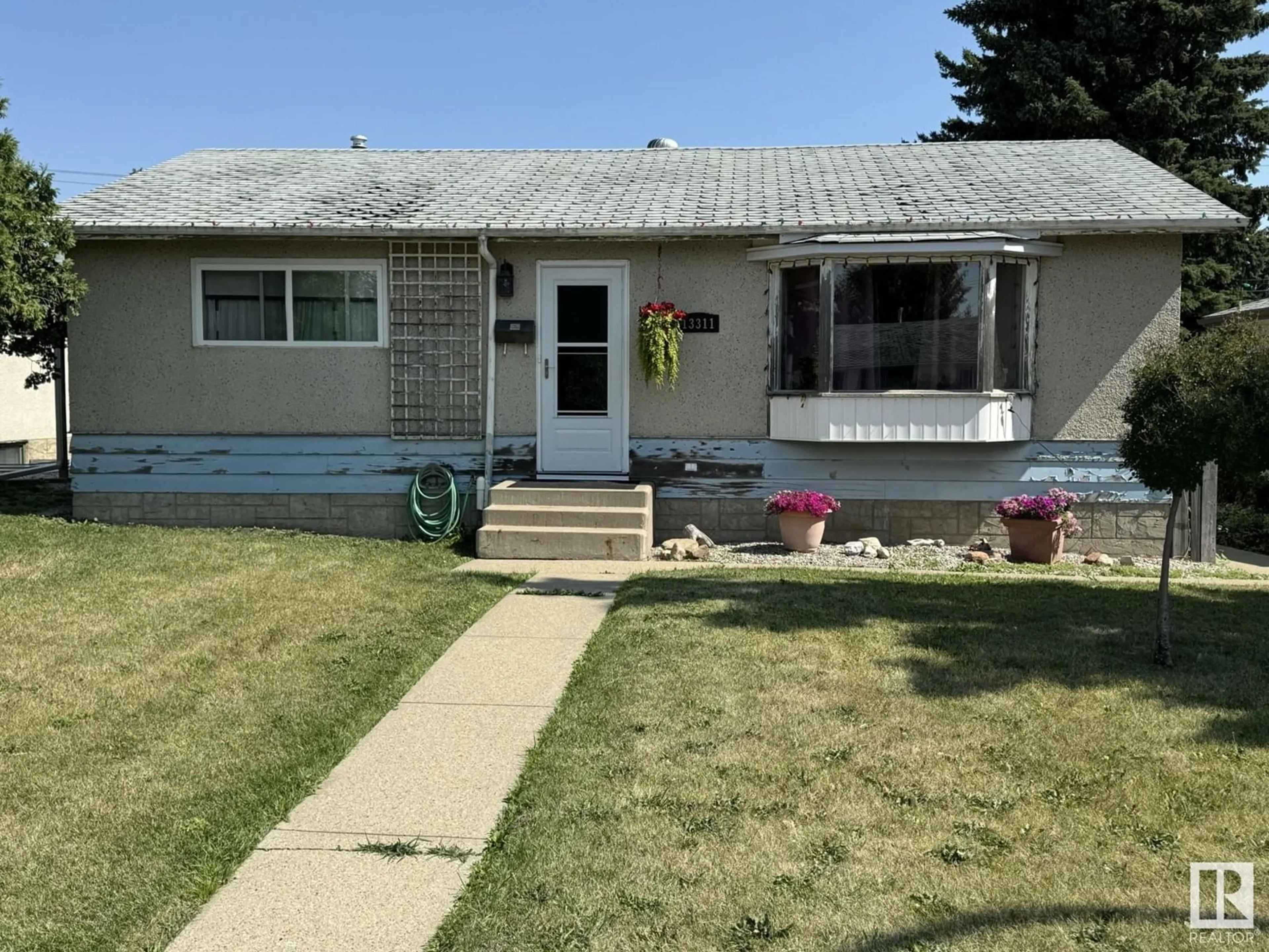 Frontside or backside of a home for 13311 59 ST NW, Edmonton Alberta T5A0R8