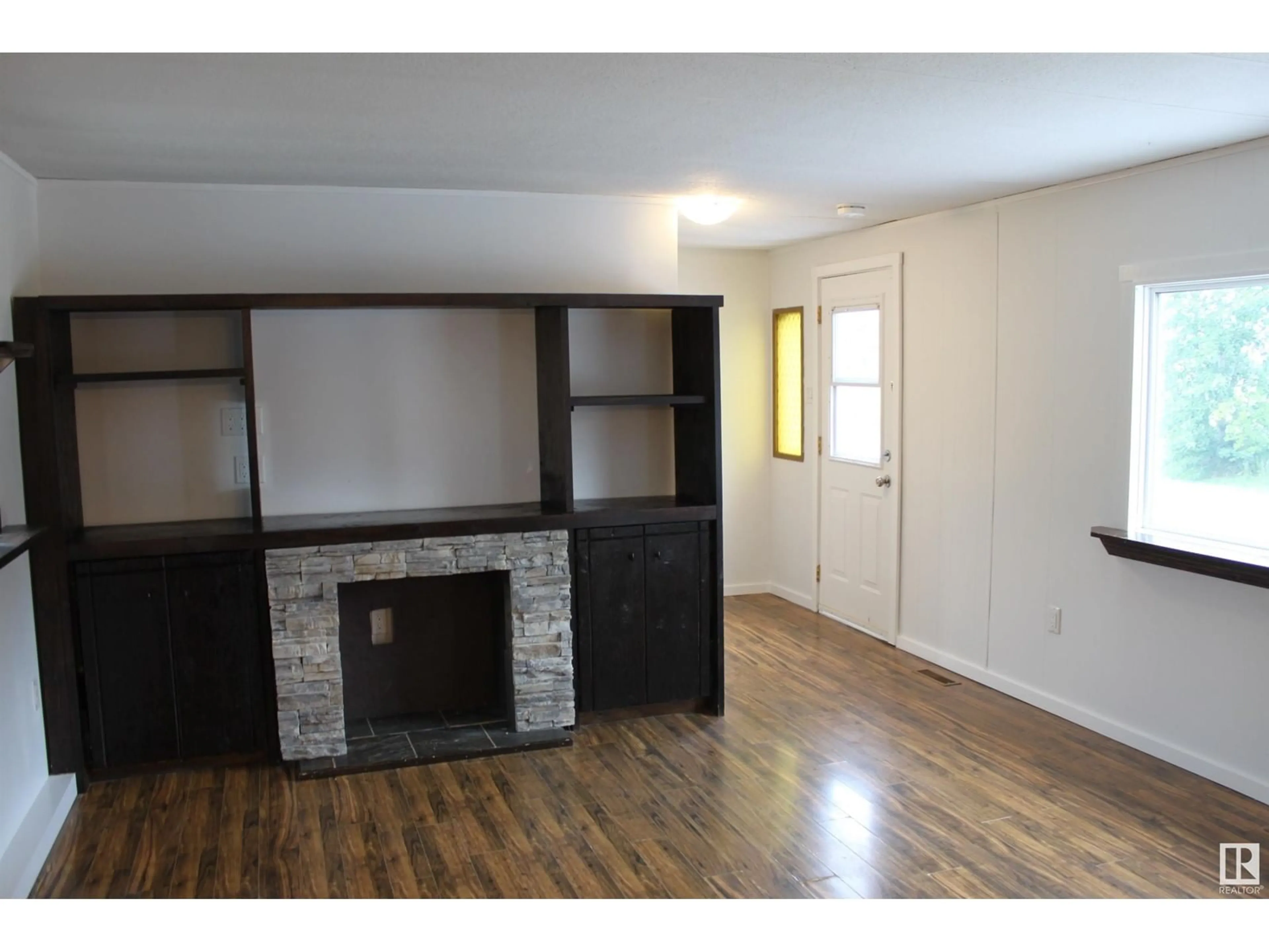 A pic of a room, wood floors for #16 5407 52A St., Tofield Alberta T0B4J0