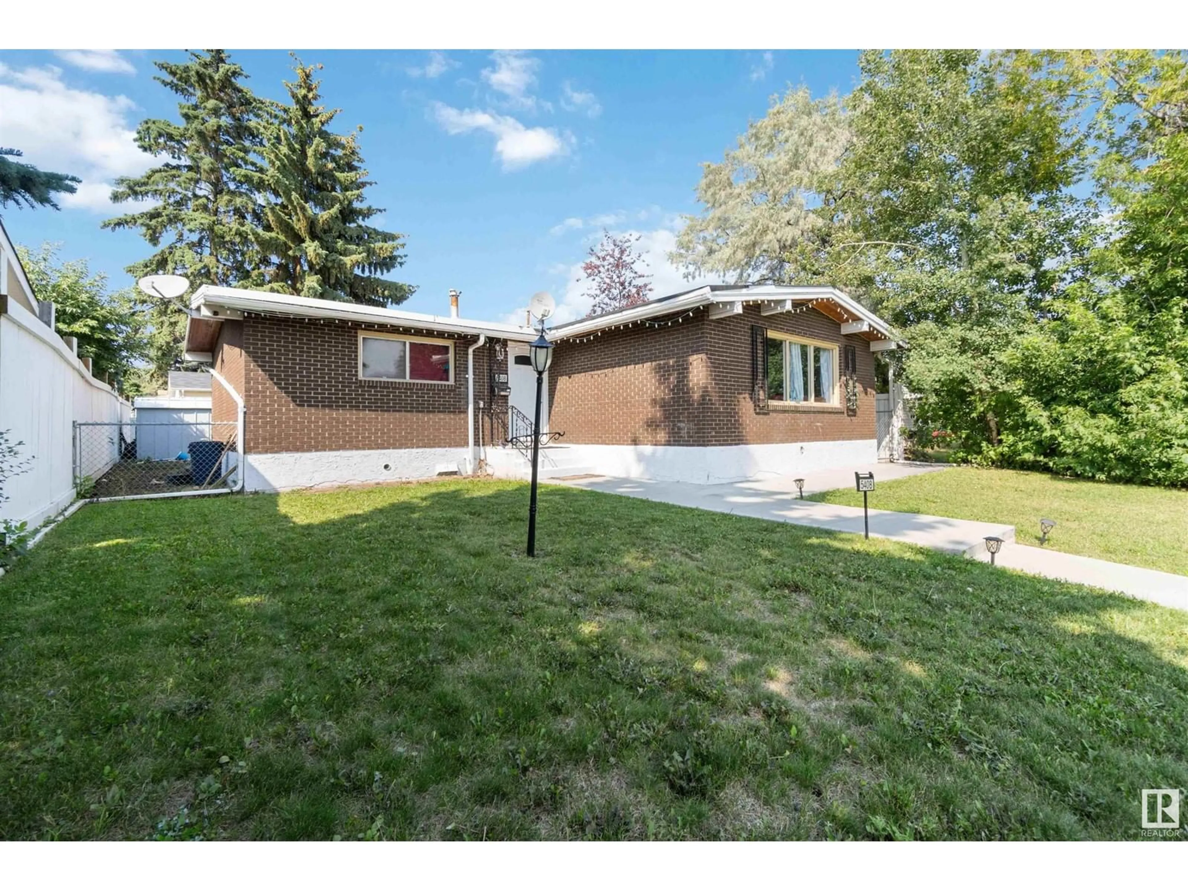 Frontside or backside of a home, the fenced backyard for 5408 139 AV NW, Edmonton Alberta T5A1E6