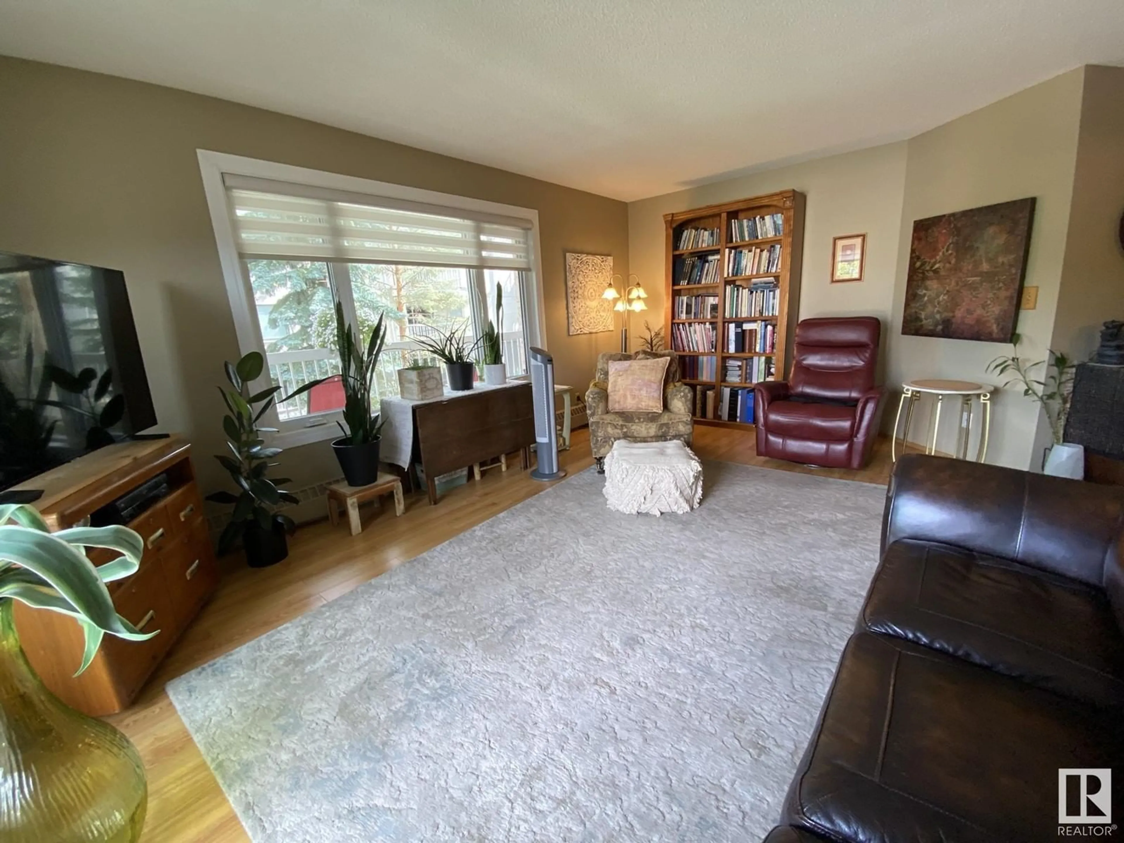 Living room, wood floors for #211 10935 21 AV NW, Edmonton Alberta T6J6R3