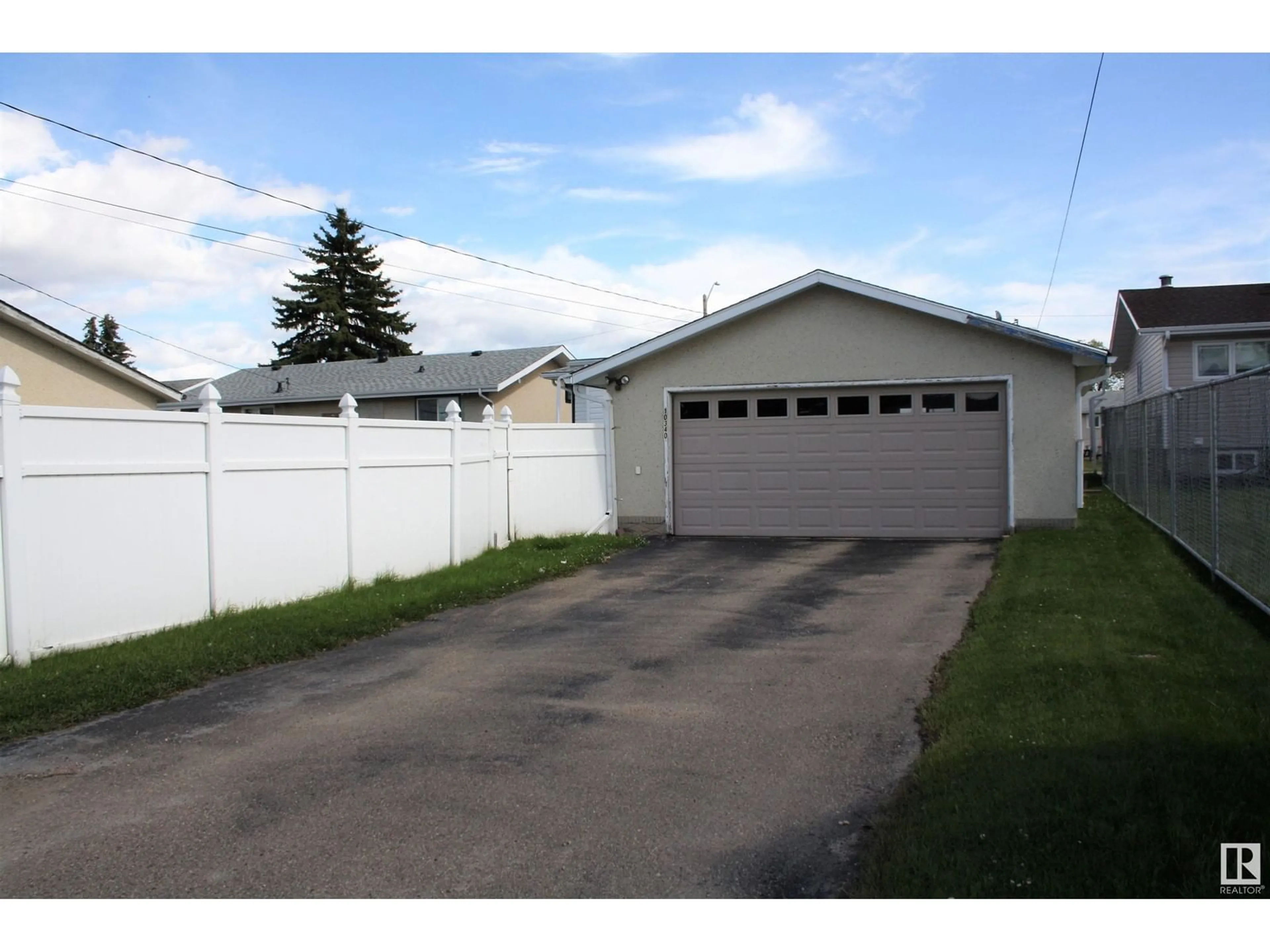 Frontside or backside of a home, the fenced backyard for 10340 108 Ave, Westlock Alberta T7P1J3