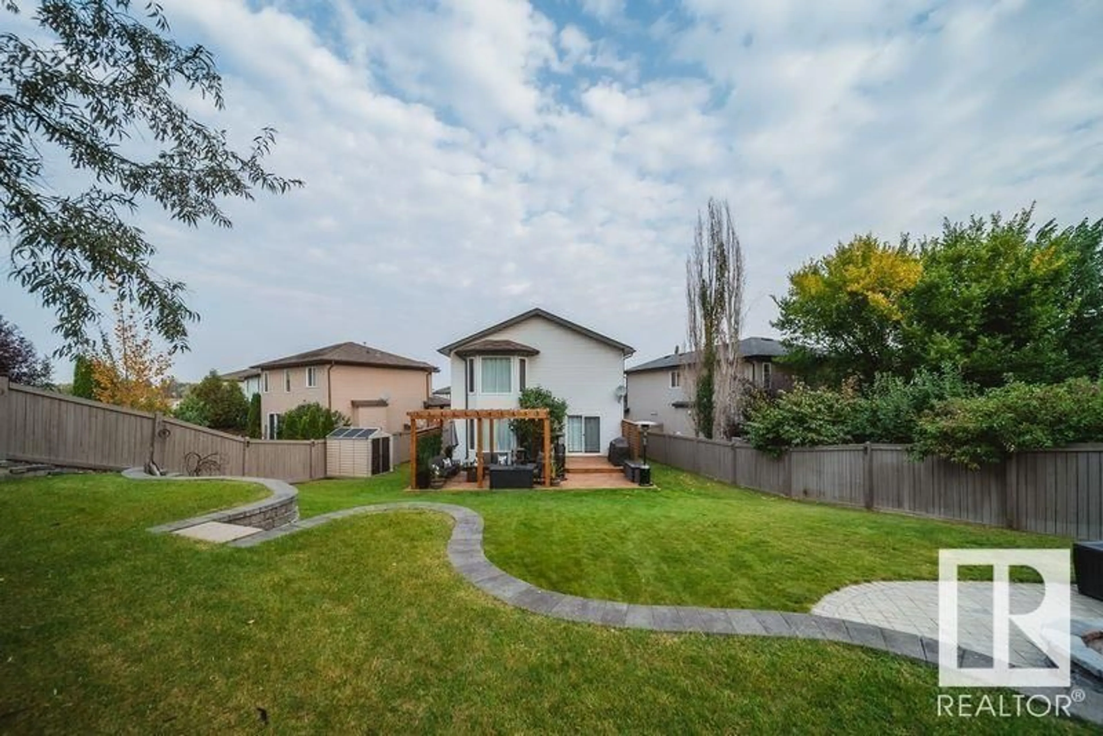 Frontside or backside of a home, the fenced backyard for 224 HYNDMAN CR NW, Edmonton Alberta T5A5H9