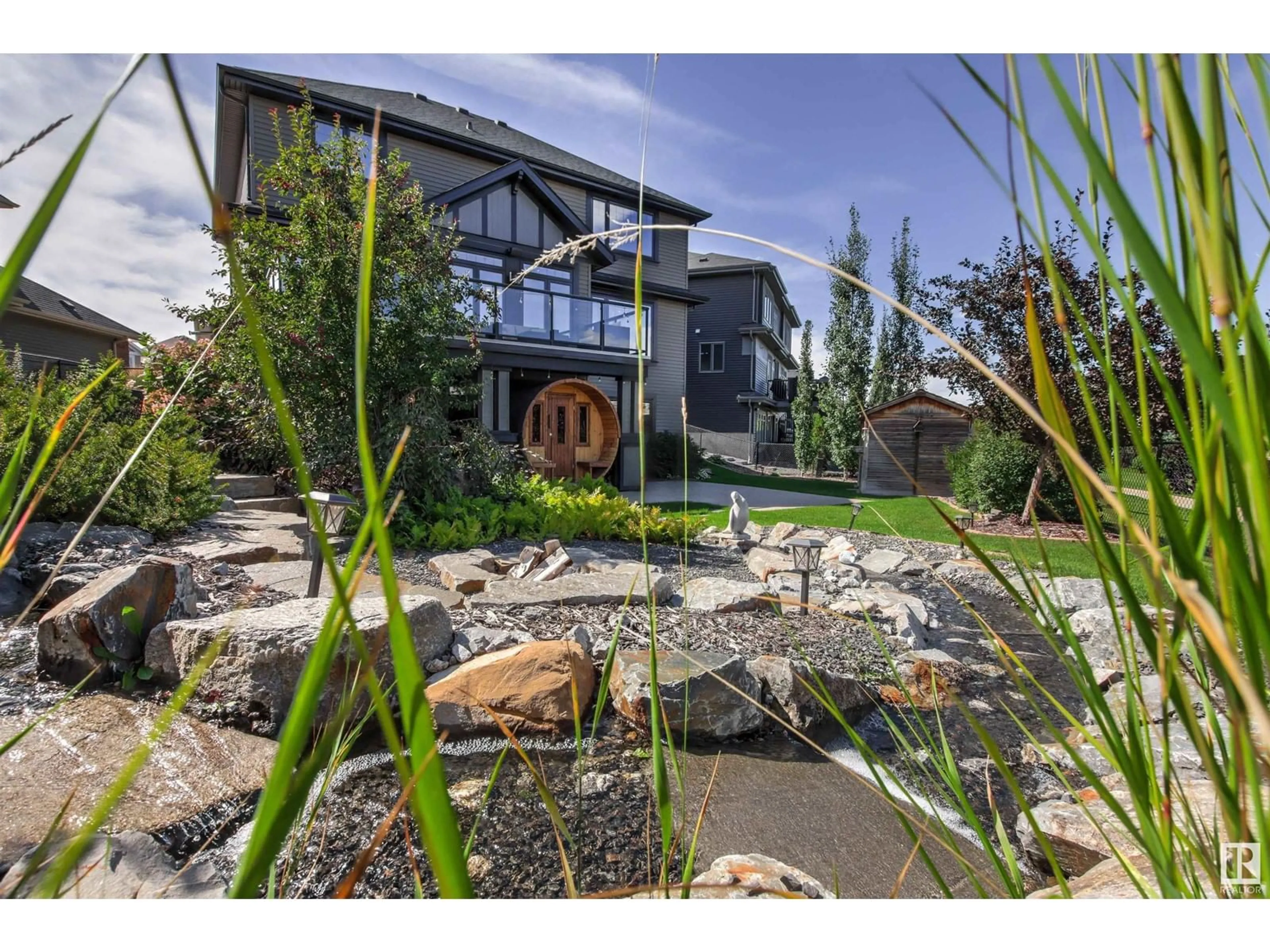 A pic from exterior of the house or condo, the fenced backyard for 620 WINDERMERE CO NW, Edmonton Alberta T6W0T2