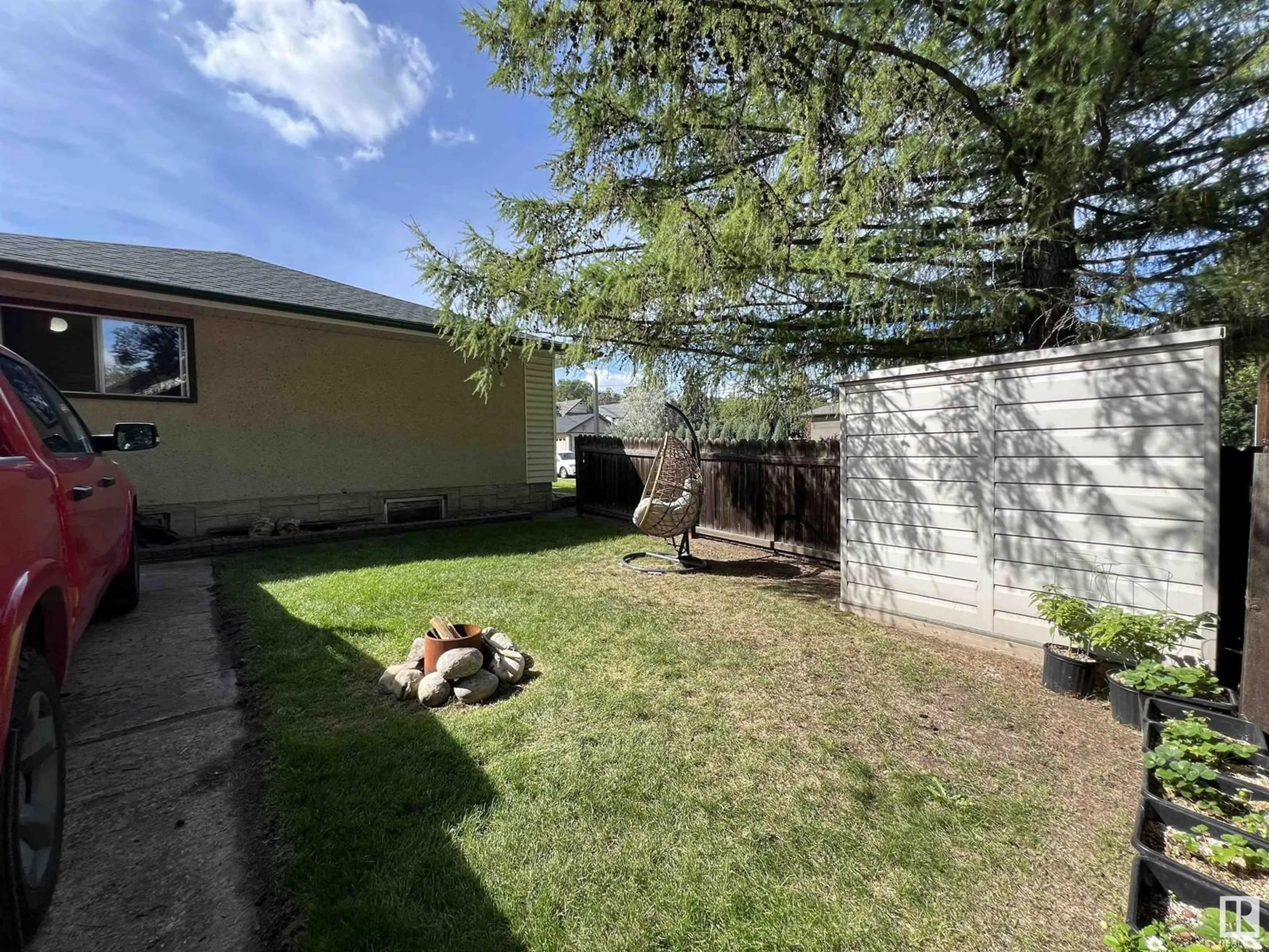 Patio, the fenced backyard for 8803 102 AV NW, Edmonton Alberta T5H0E1