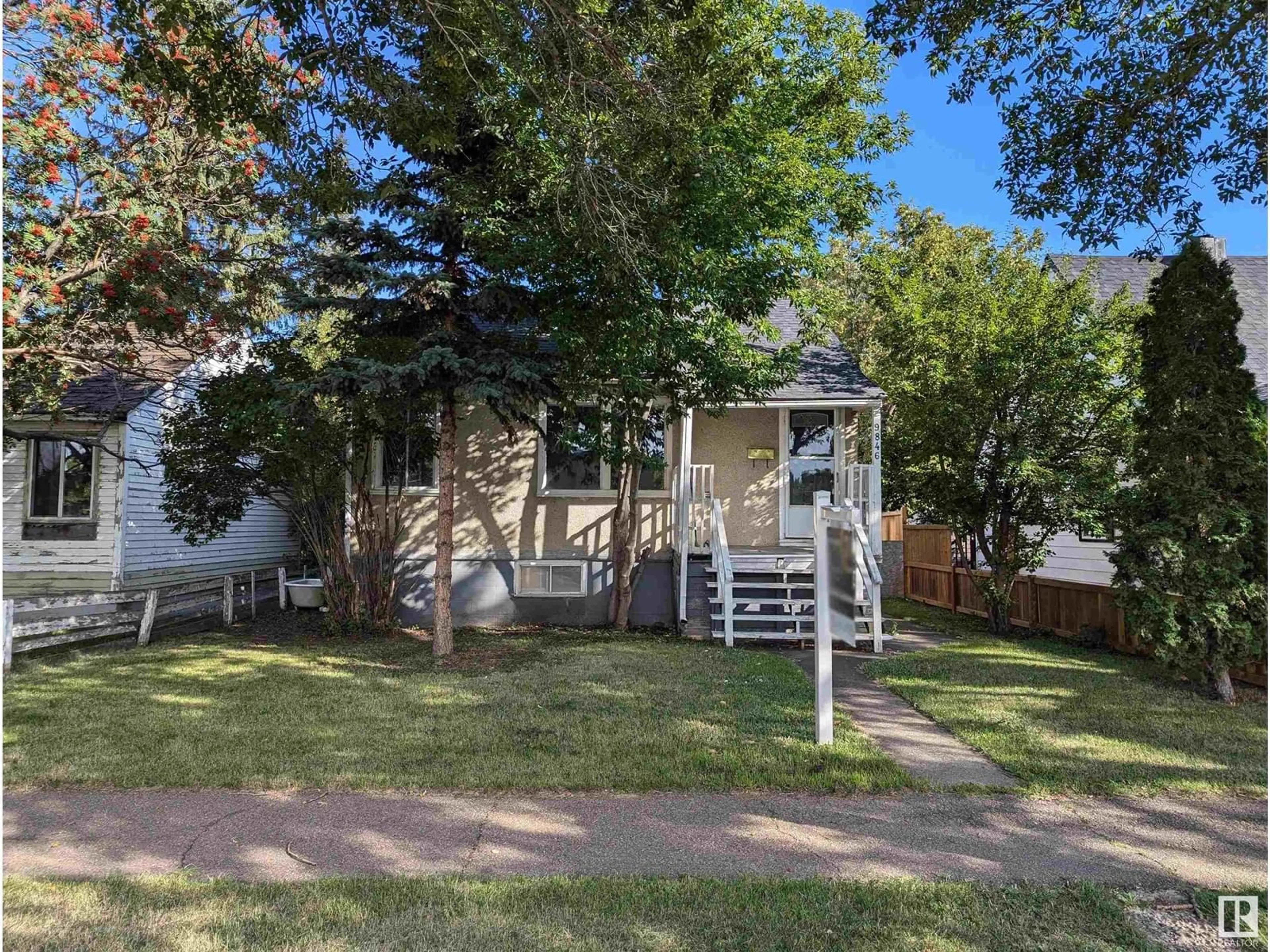 Frontside or backside of a home, the fenced backyard for 9846 72 AV NW, Edmonton Alberta T6E0Z1