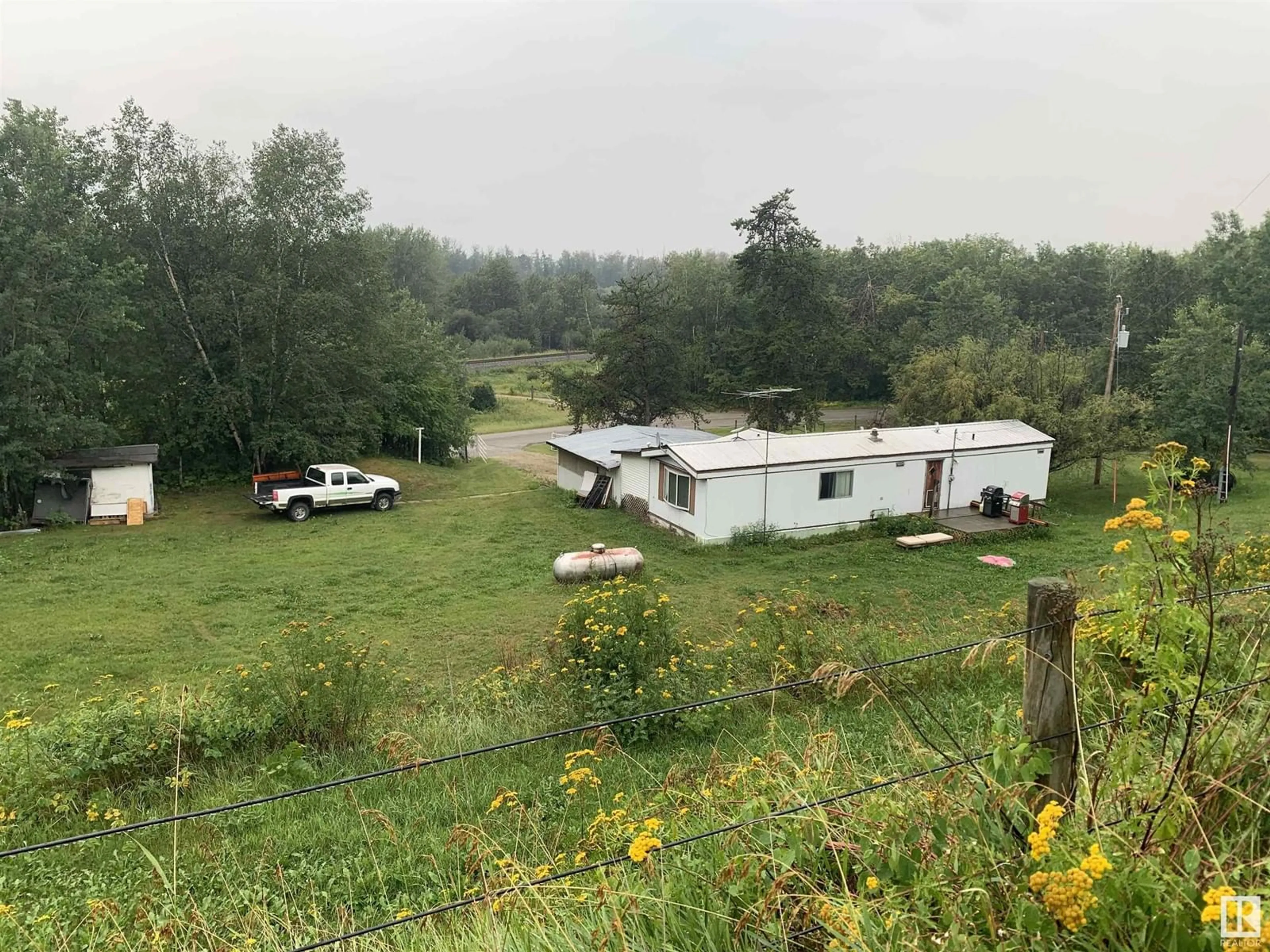 A pic from outside/outdoor area/front of a property/back of a property/a pic from drone, unknown for 102 1A AV, Rural Parkland County Alberta T0E0V0