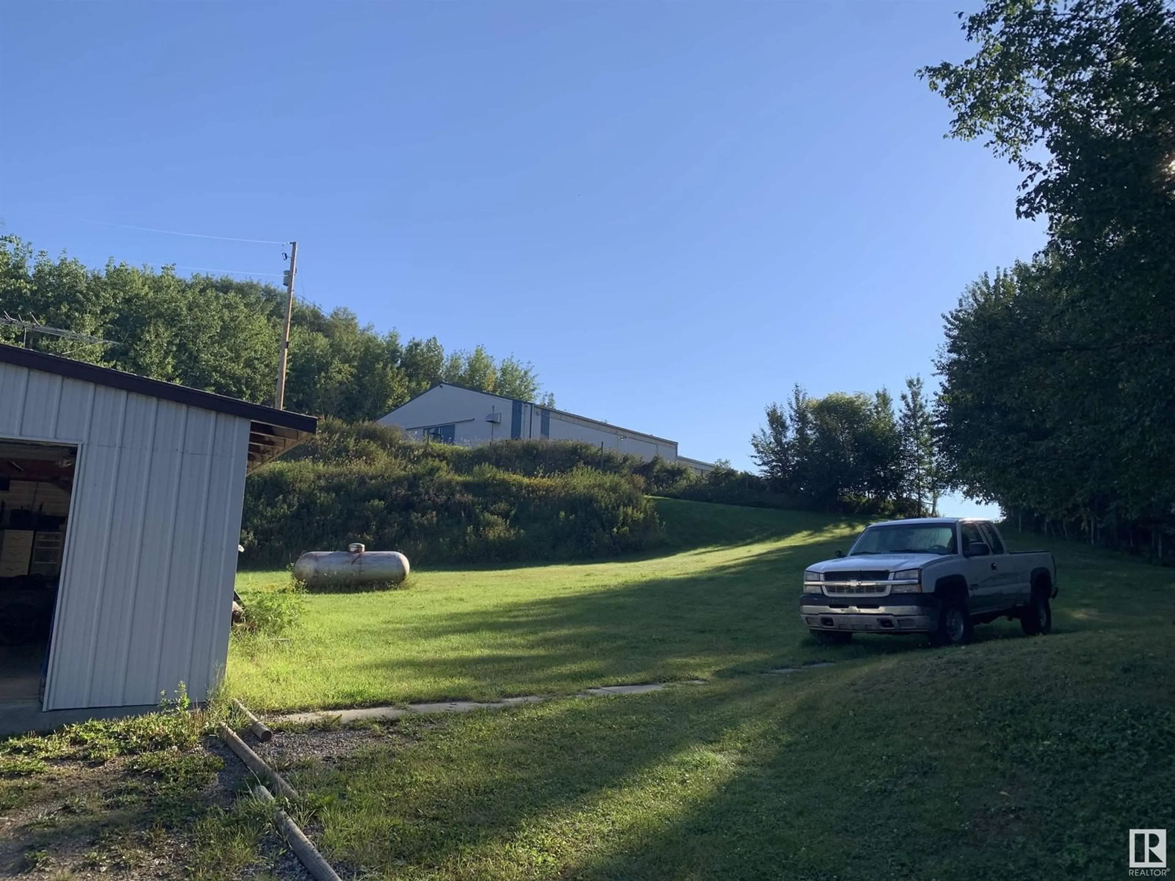 A pic from outside/outdoor area/front of a property/back of a property/a pic from drone, unknown for 102 1A AV, Rural Parkland County Alberta T0E0V0