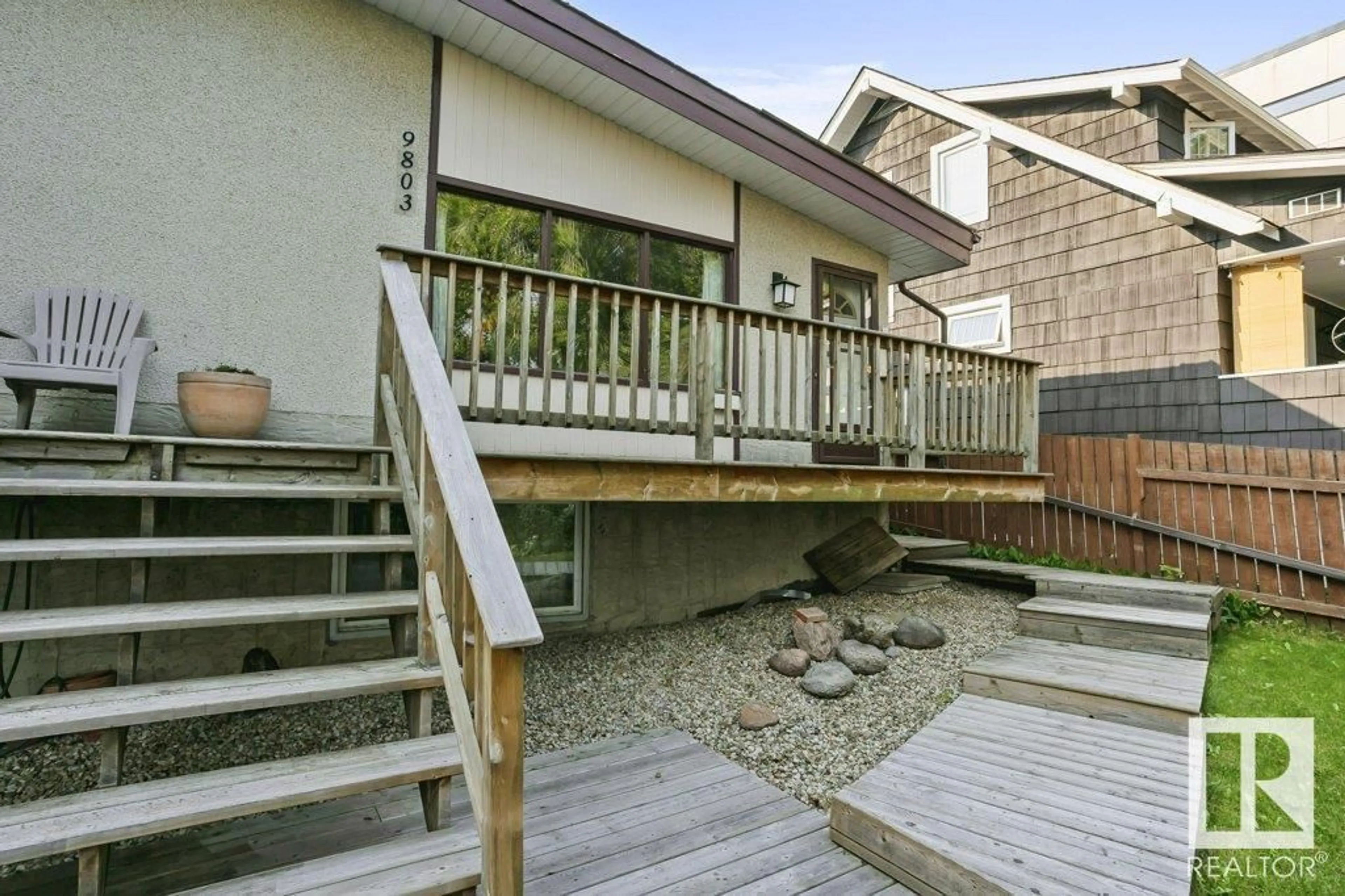 Frontside or backside of a home, the fenced backyard for 9803 92 AV NW, Edmonton Alberta T6E2V4