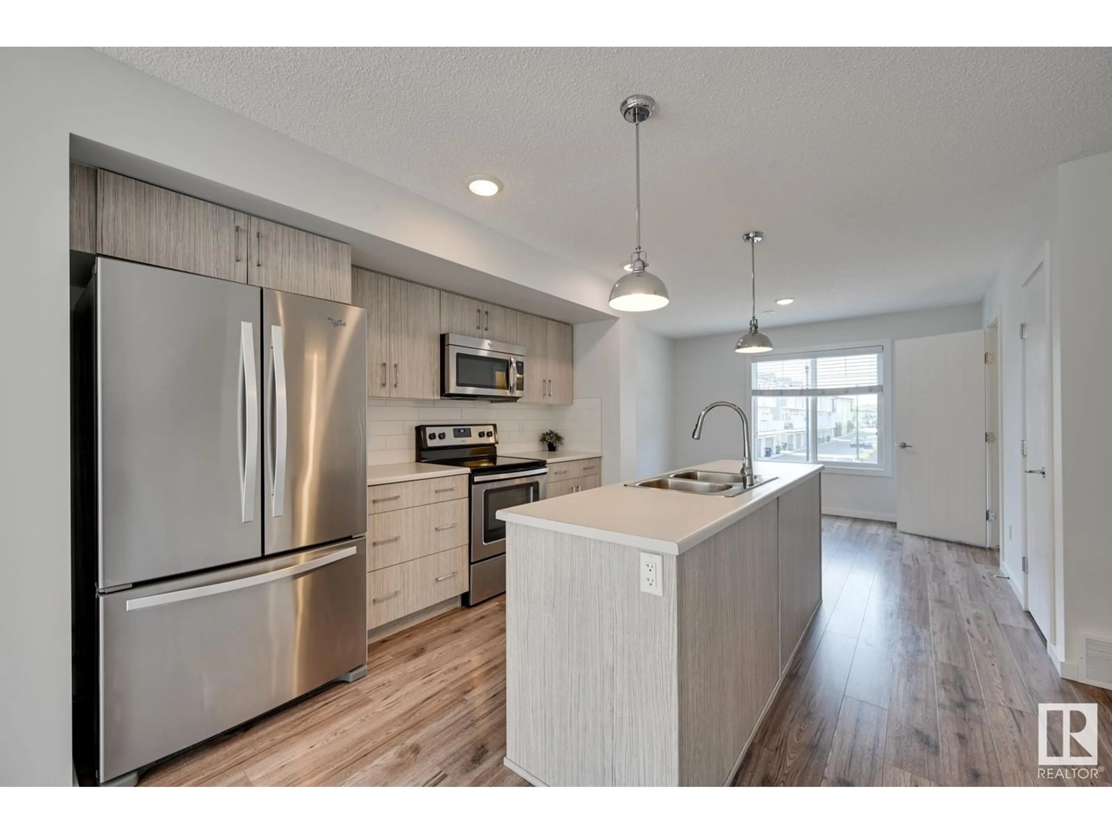 Open concept kitchen for #26 2215 24 ST NW, Edmonton Alberta T6T1A6