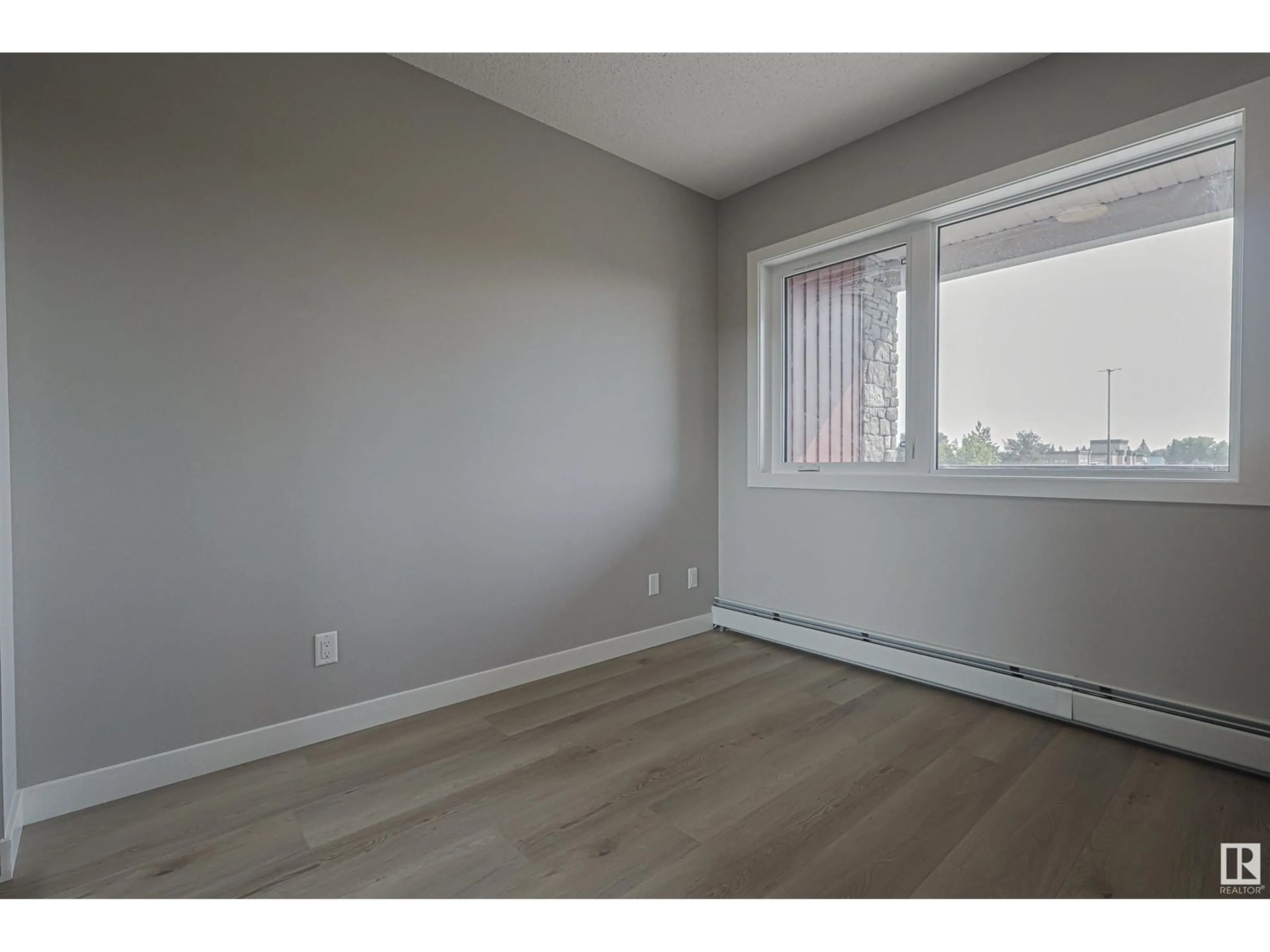 A pic of a room, wood floors for #217 12804 140 AV NW, Edmonton Alberta T6V1K4