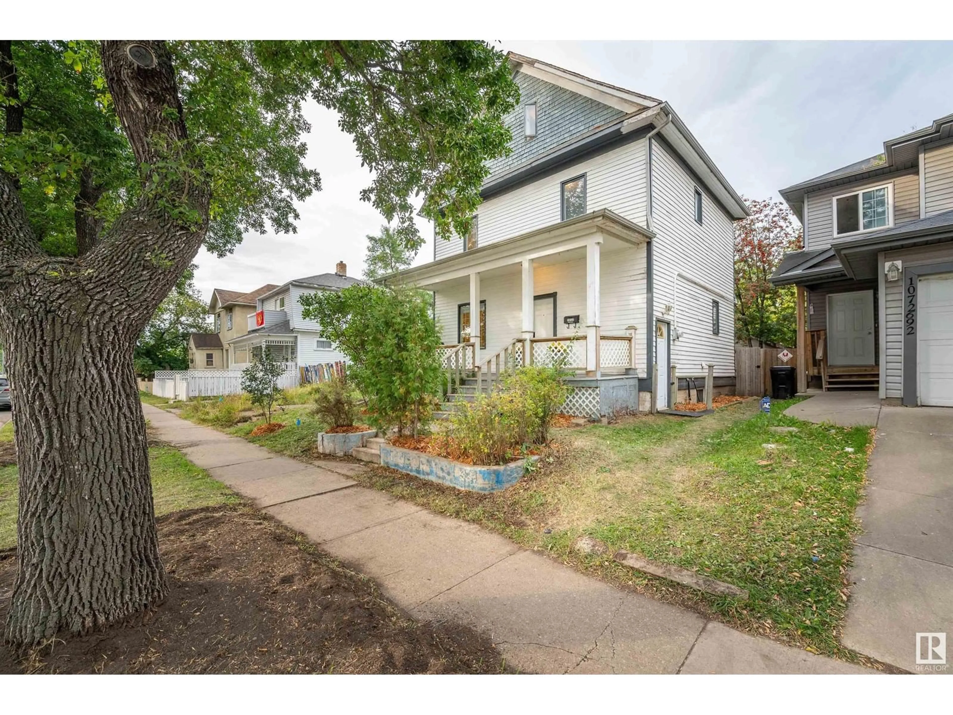 Frontside or backside of a home, the fenced backyard for 10722 92 ST NW, Edmonton Alberta T5H1V4