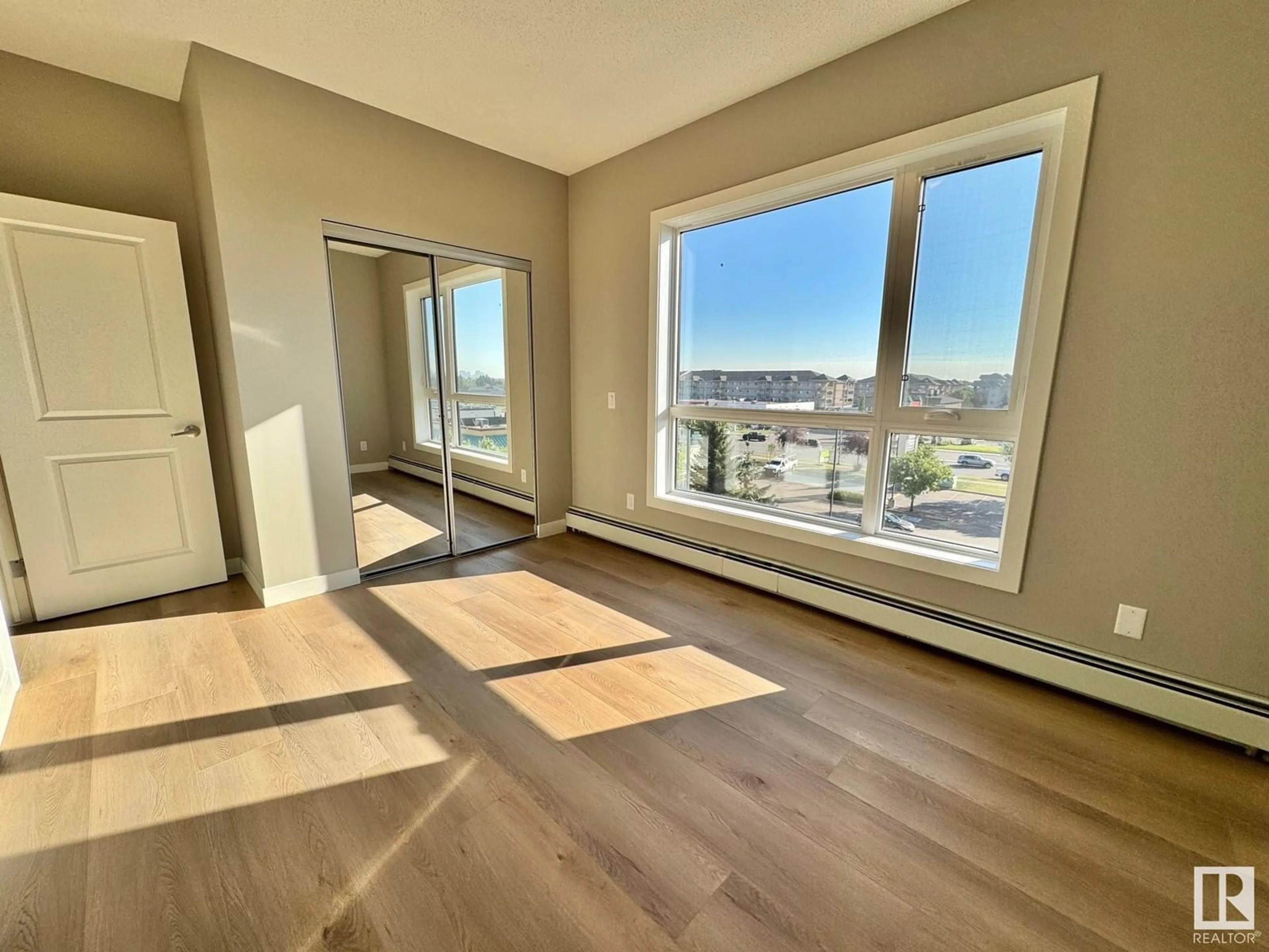 A pic of a room, wood floors for #428 12804 140 AV NW, Edmonton Alberta T6V0M3