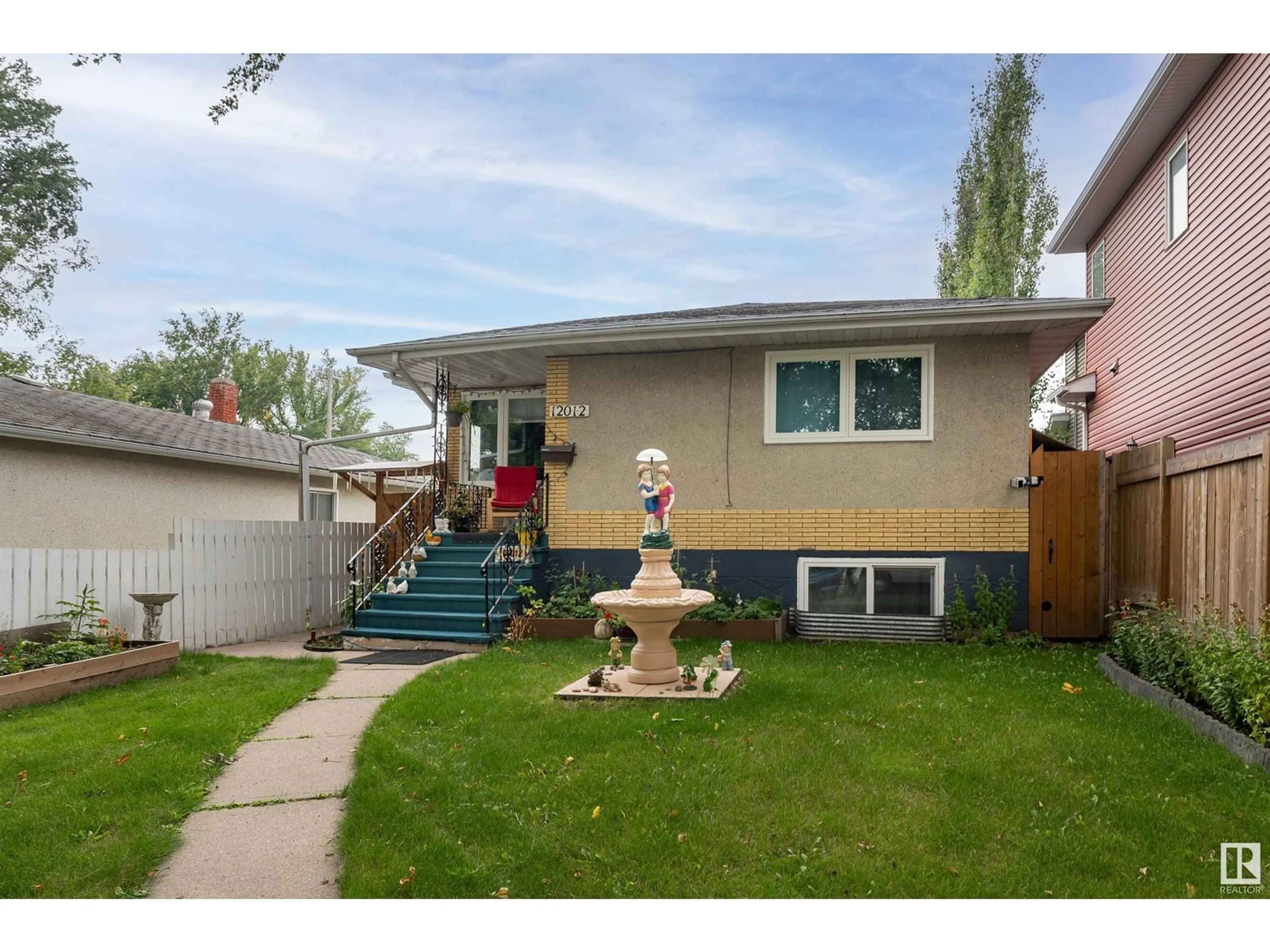 Frontside or backside of a home, the fenced backyard for 12012 65 ST NW, Edmonton Alberta T5W4L7