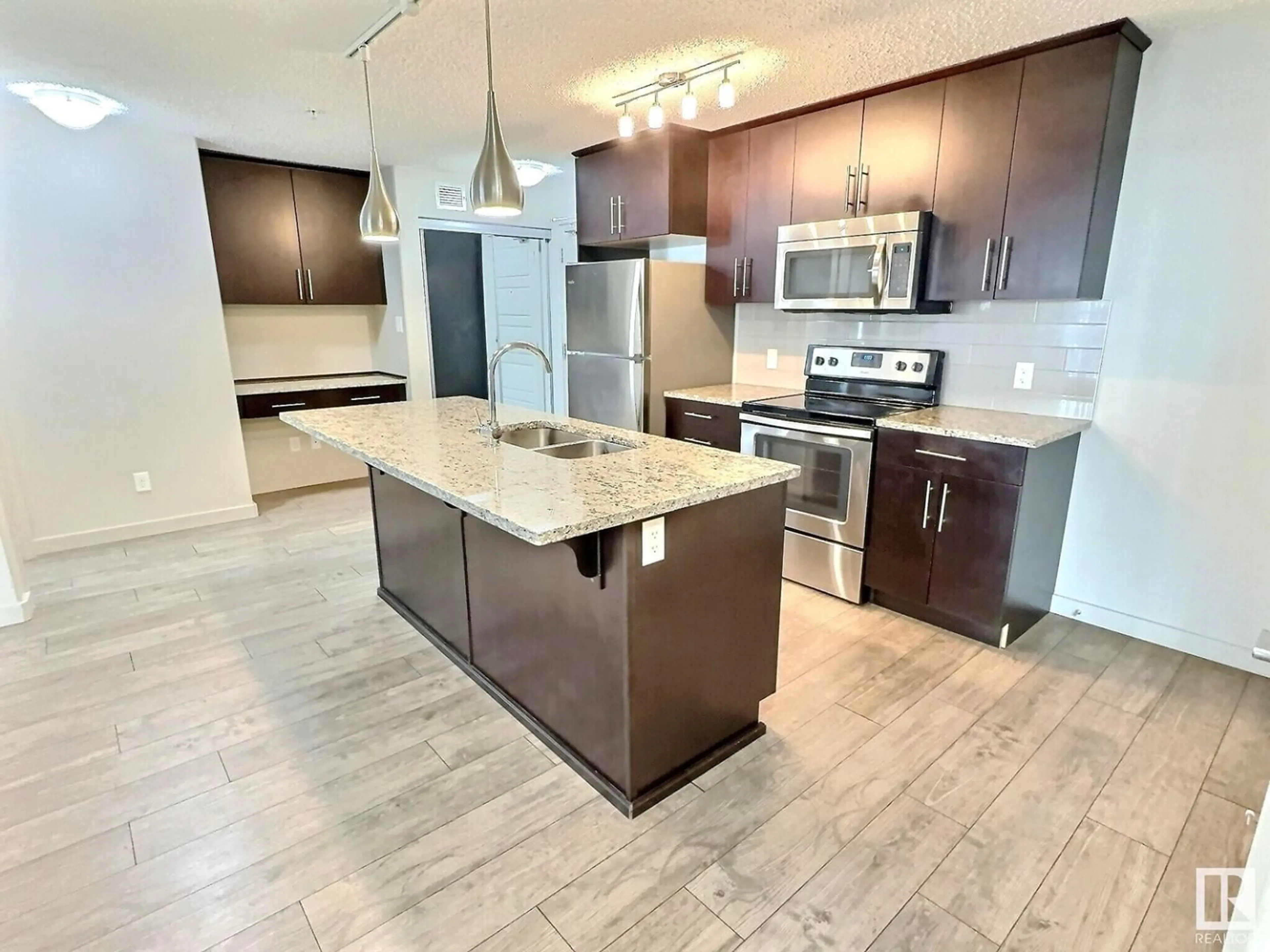 Open concept kitchen for #215 5510 Schonsee DR NW, Edmonton Alberta T5Z0N9