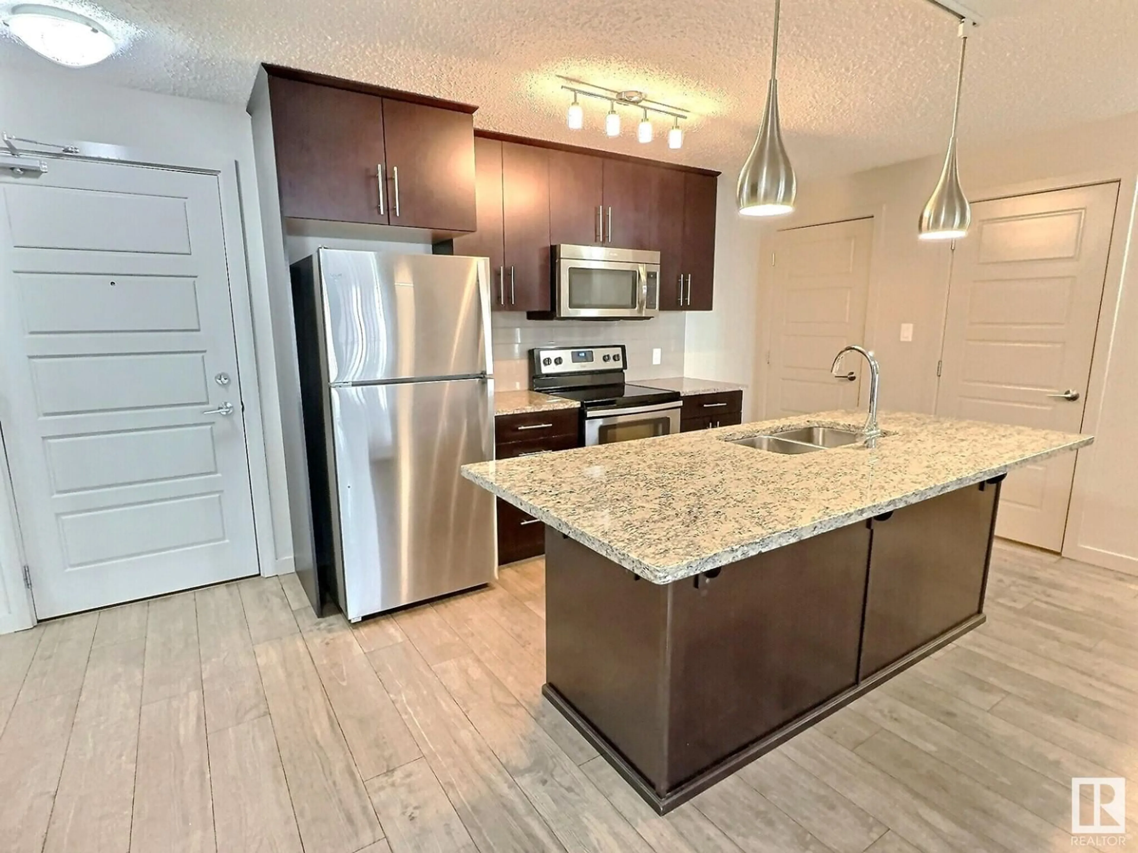 Open concept kitchen for #215 5510 Schonsee DR NW, Edmonton Alberta T5Z0N9