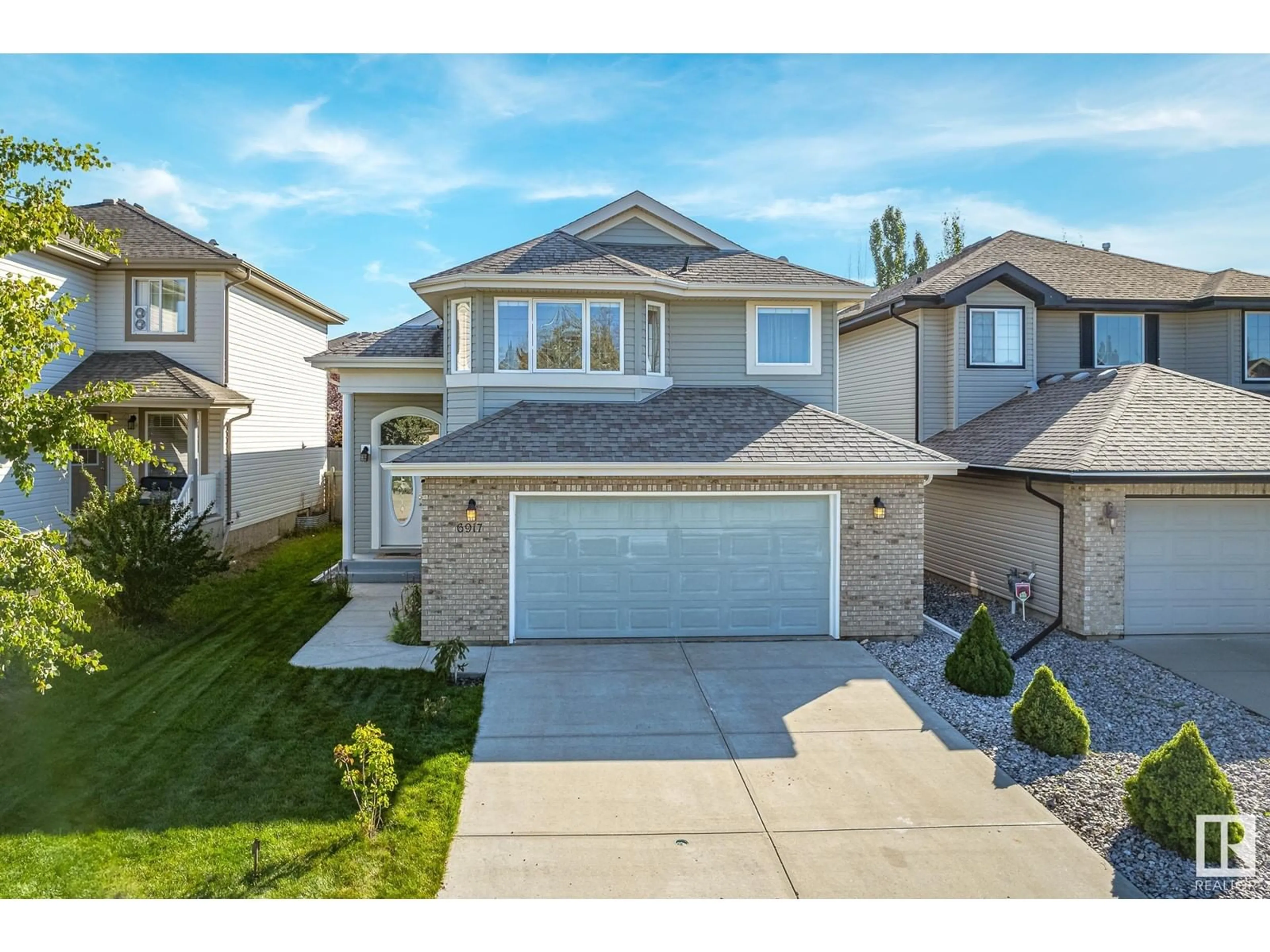 Frontside or backside of a home, the street view for 6917 STROM LN NW, Edmonton Alberta T6R0G3