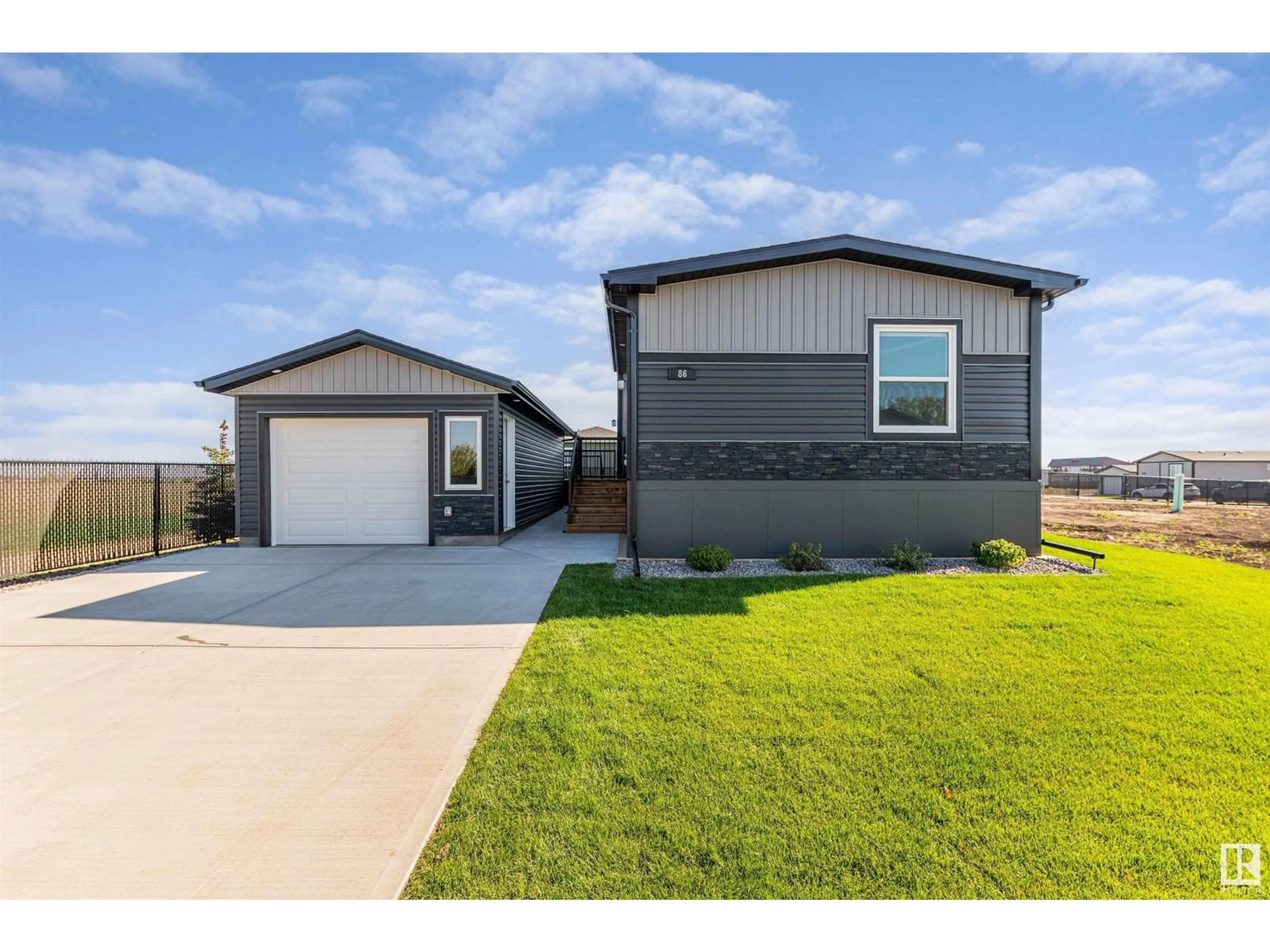 Frontside or backside of a home, the fenced backyard for 86 Meadowview RD, Morinville Alberta T8R2P7